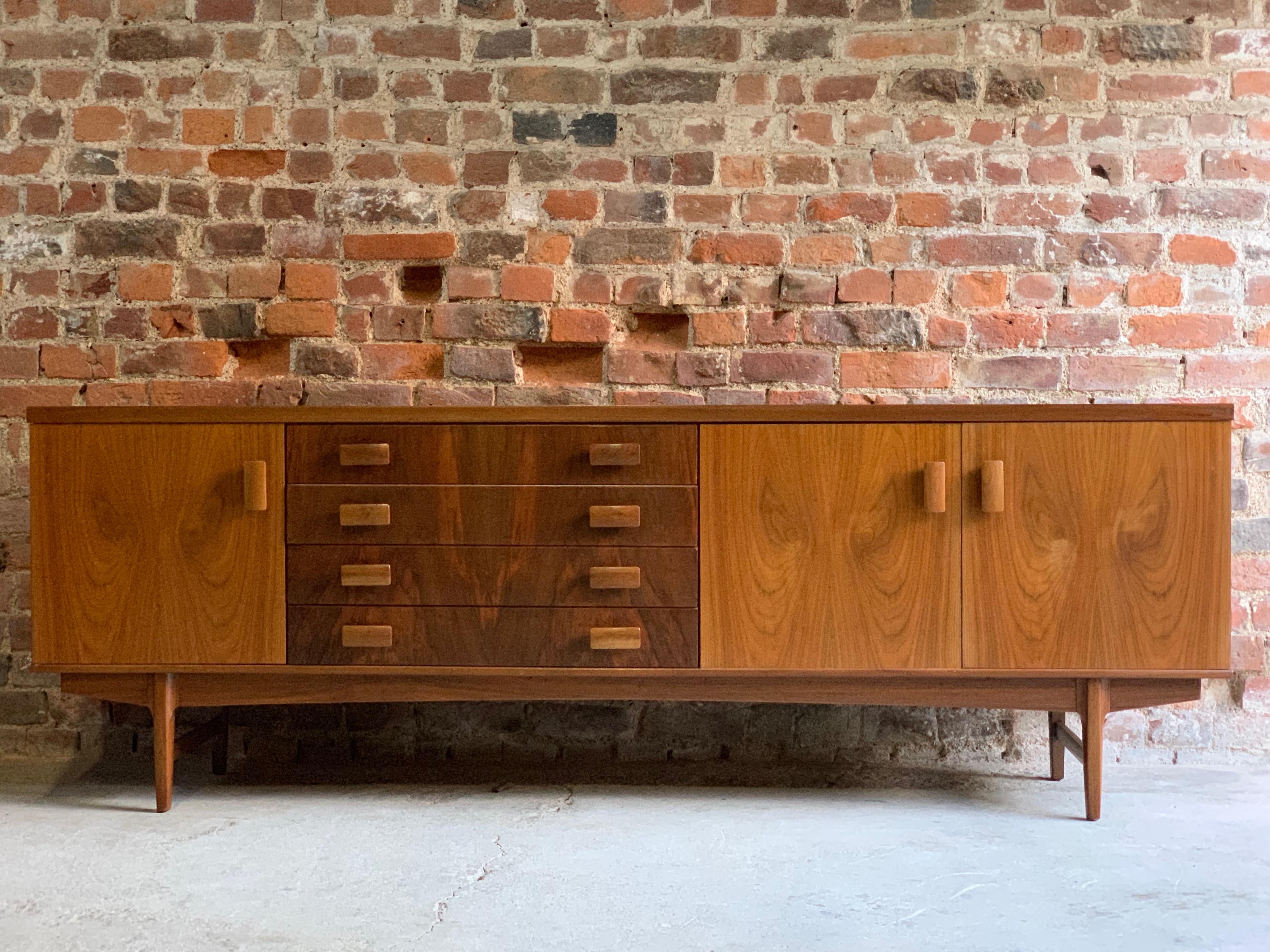 Midcentury rosewood and teak sideboard circa 1960 BCM British cabinet makers.

A truly stunning BCM (British Cabinet Makers) 7ft teak and rosewood sideboard credenza manufactured in Britain, circa 1960. The rectangular teak top with rosewood sides