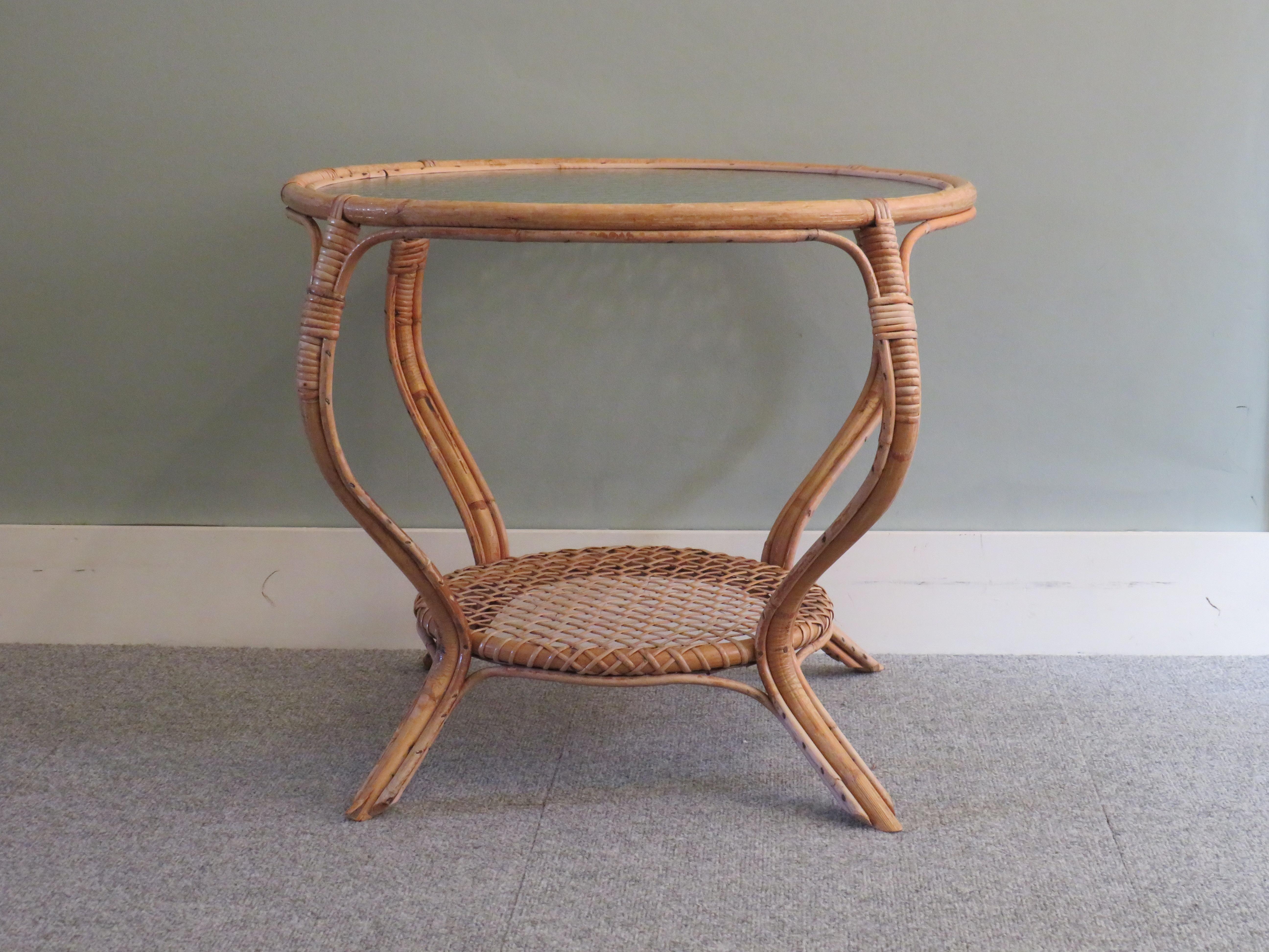 Round coffee table 1960s, France.
The table has a bamboo frame and a fixed bubble glass top.
The table has a diameter of 70 cm and a height of 55 cm.
The diameter of the glass top is 65 cm and the diameter of the bottom wicker top is 40 cm, this