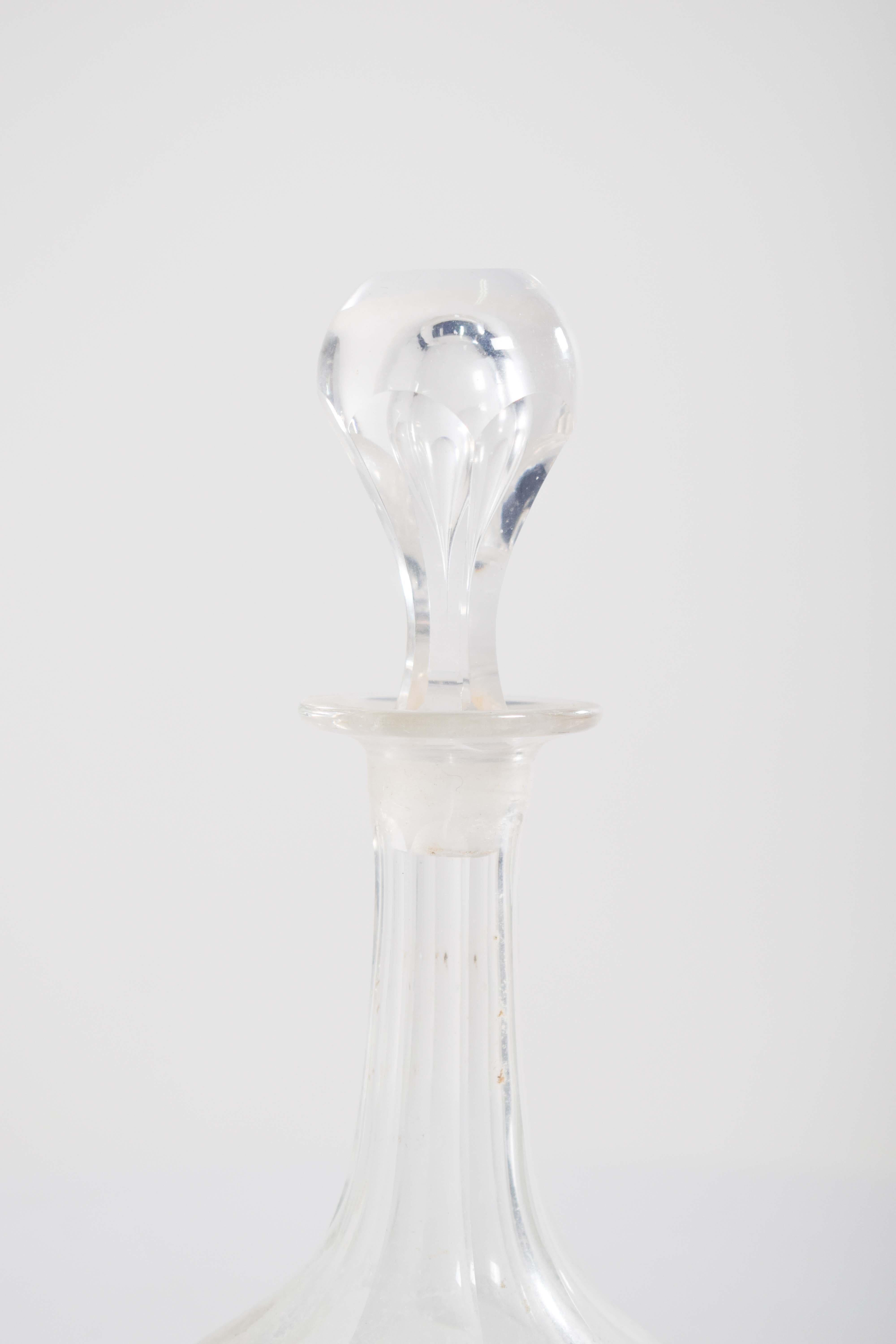 Questa bottiglia di liquore, realizzata in vetro tagliato, è un pezzo sofisticato ed elegante, pensato per farsi notare. Il flacone stesso ha linee nitide e pulite e un tappo a strappo. Il vetro tagliato crea una superficie splendidamente