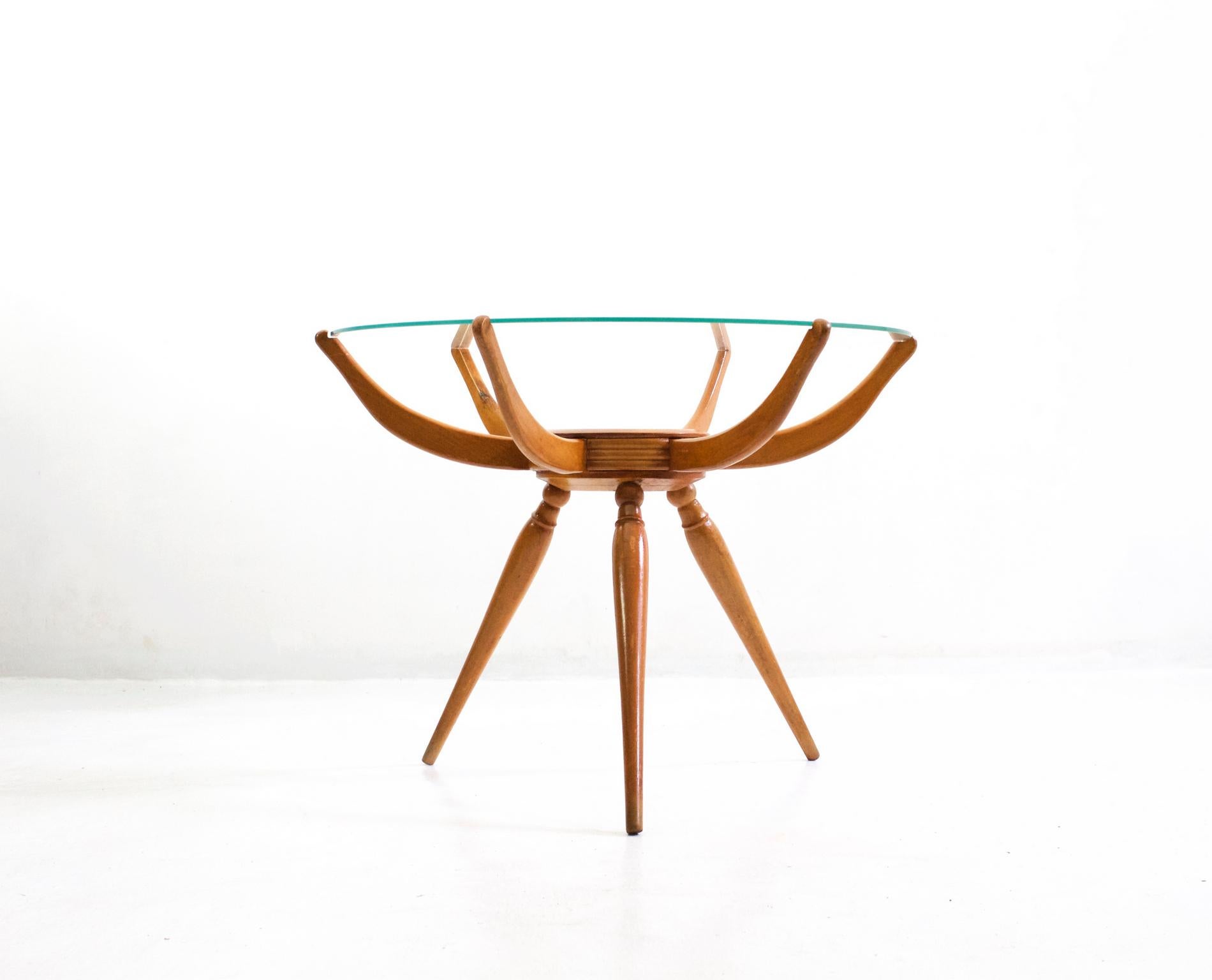 Round tripod table by Italian designer Carlo de Carli in beech with a round glass top which has been fully restored.