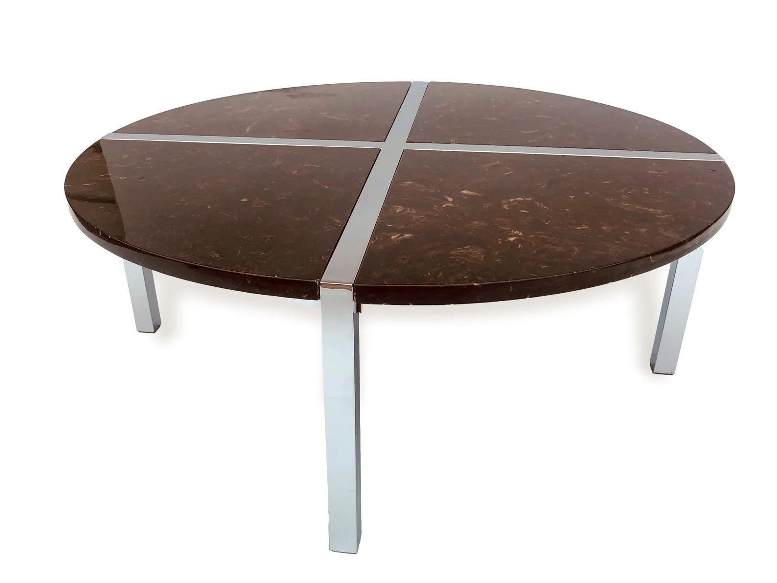 This incredibly unique vintage Mid-Century Modern chrome and marbled resin round coffee table in the style of Milo Baughman is circa 1970. The sleek design features a chrome-plated silver frame with brown marbled resin pie-shaped inserts. The table