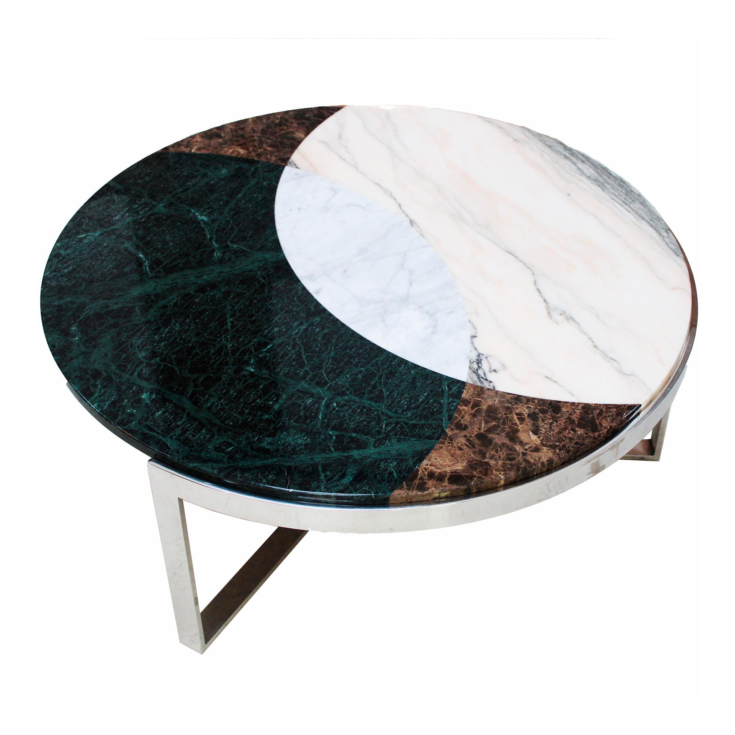 This round coffee table is a true masterpiece crafted with unparalleled artistry and timeless elegance. This stunning piece combines the rich history of antique steel plate for its base and an exquisite marquetry technique for its top, this piece of