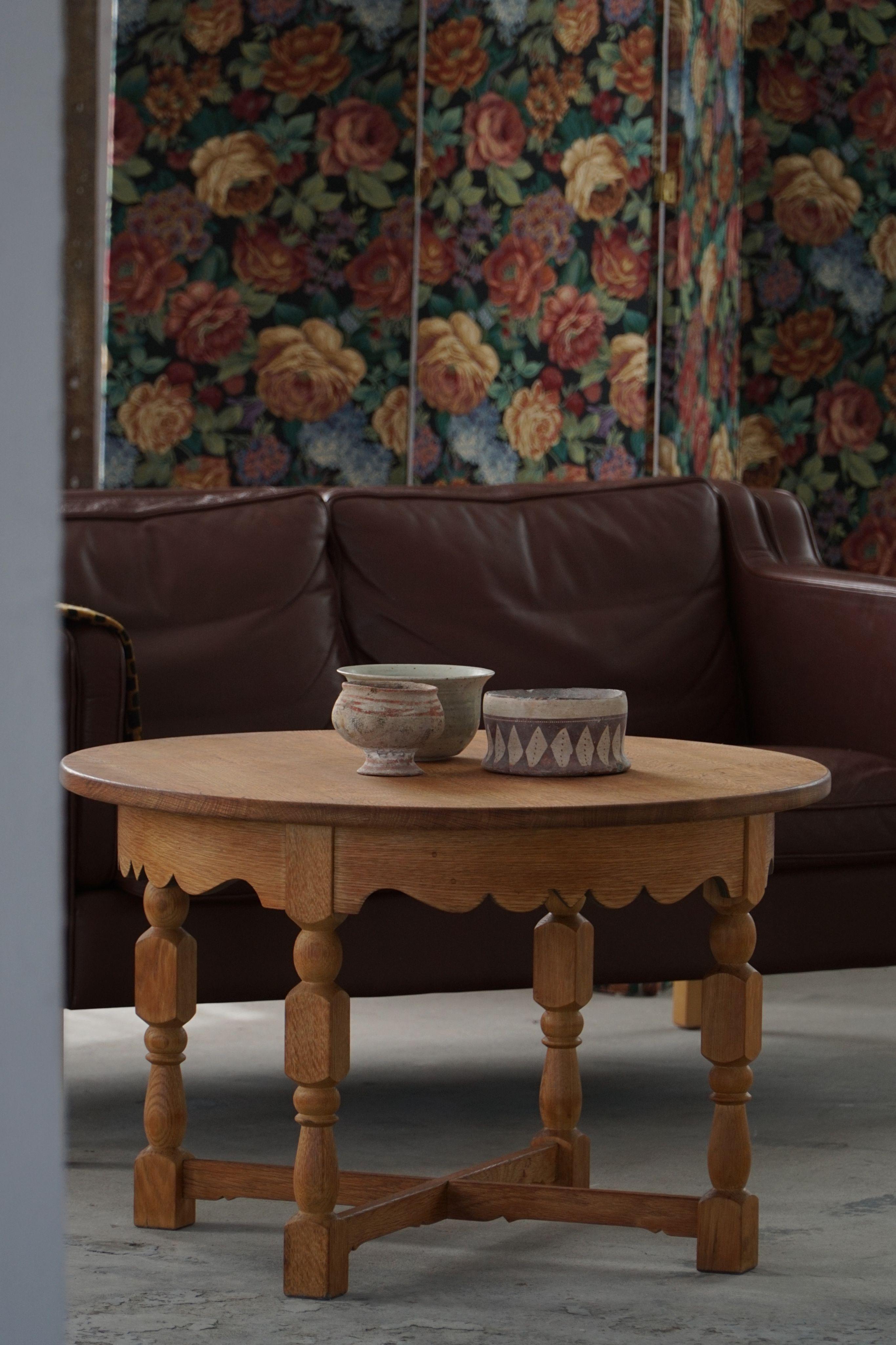 Crafted in Denmark during the 1960s by a skilled cabinetmaker, this round side table is attributed to architect Henning Kjærnulf for Nyrup Møbelfabrik. Executed in solid oak, the piece blends sculptural craftsmanship with a sense of historic