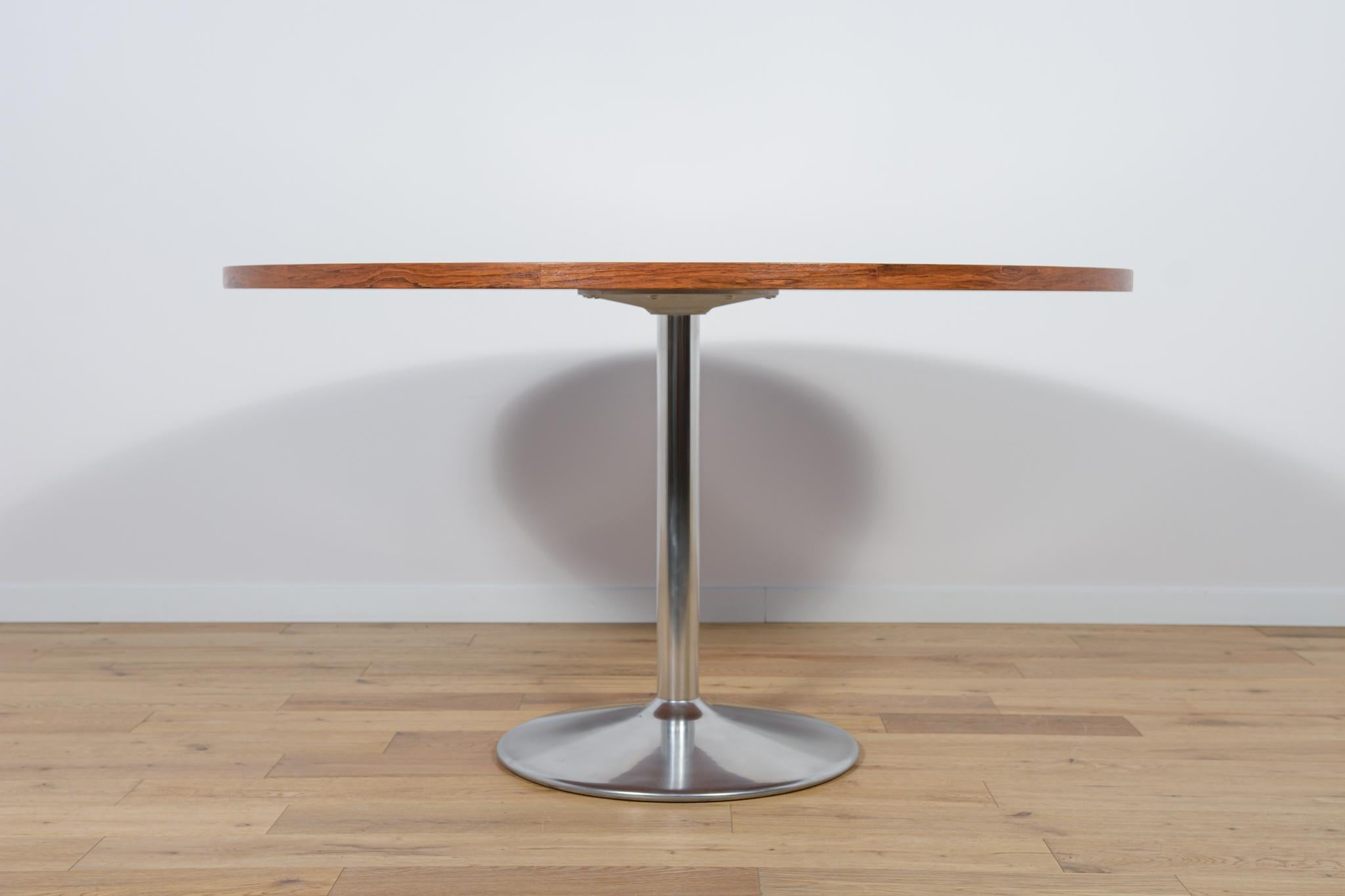The table was produced in Denmark in the 1970s. Table top made of jatobe veneer. The furniture is after a comprehensive carpentry renovation, cleaned of the old coating, finished with high-quality Danish Oil. The table base is made of aluminum has