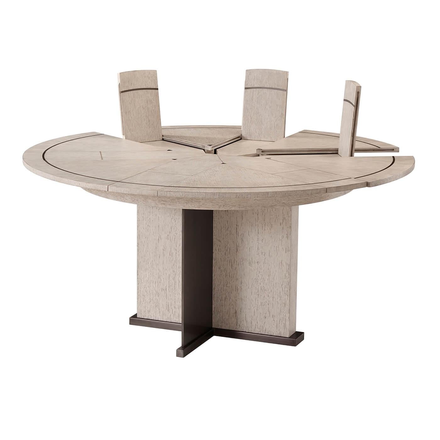 Mid-Century Modern style round extending dining table with quartered oak veneer with our gowan finish, six pie-shaped leaves and six integral fold-out leaves with matte tungsten finish metal inlaid top on a matter tungsten metal and oak crossover