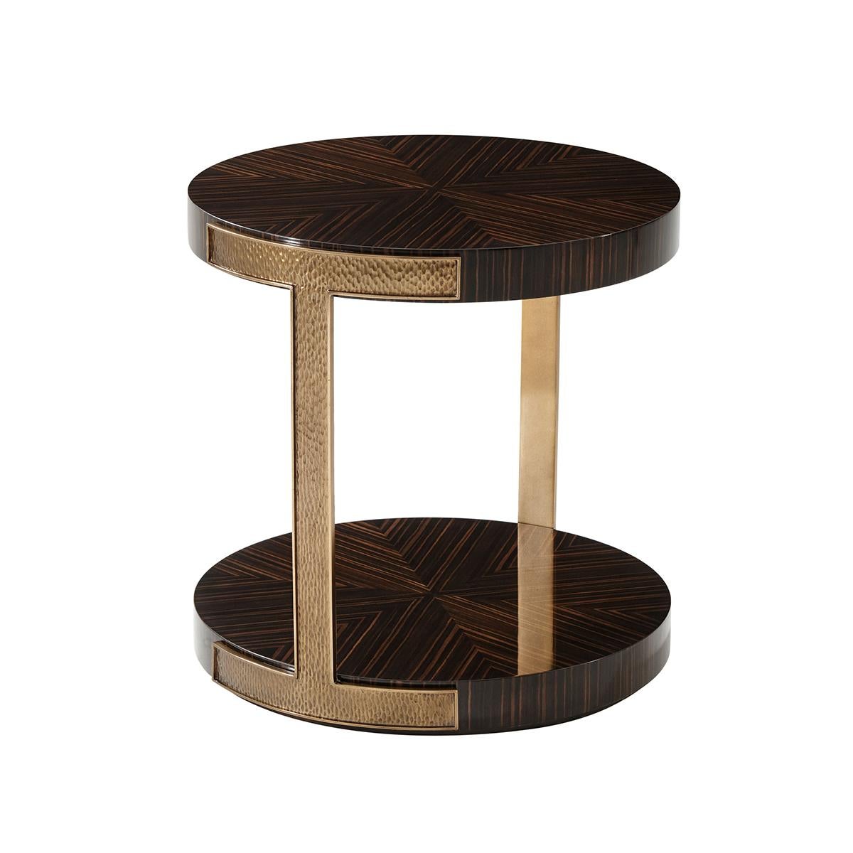With a circular top in simulated ebony veneer with a fine amara finish with a unique hand-hammered brass finish metal accents.

Dimensions: 24