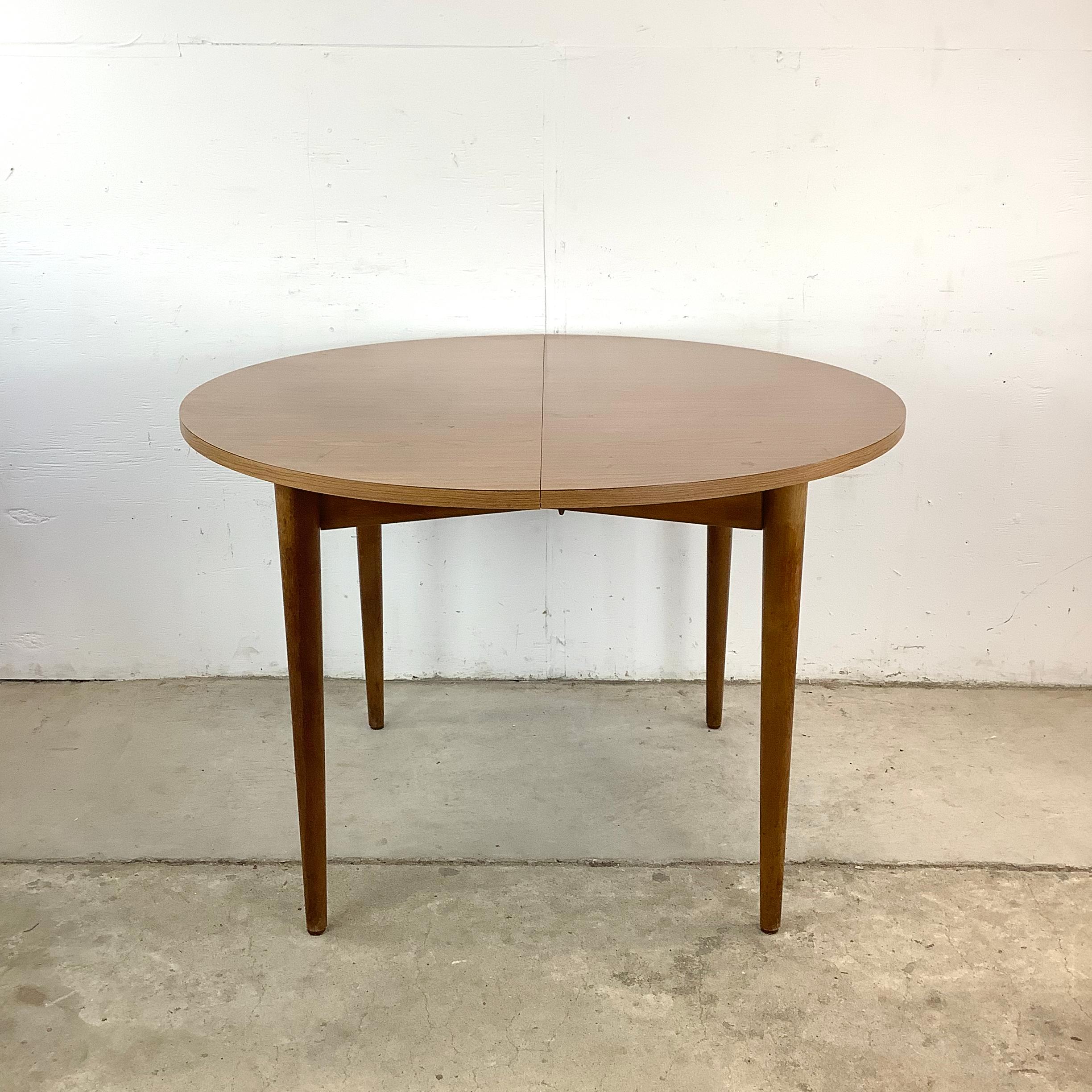 Clean lines, subtle curves, and warm tones define this petite mid-century modern kitchen table, making it a perfect fit for compact spaces that crave style without excess. Its round profile creates a soft, organic flow in the room, encouraging