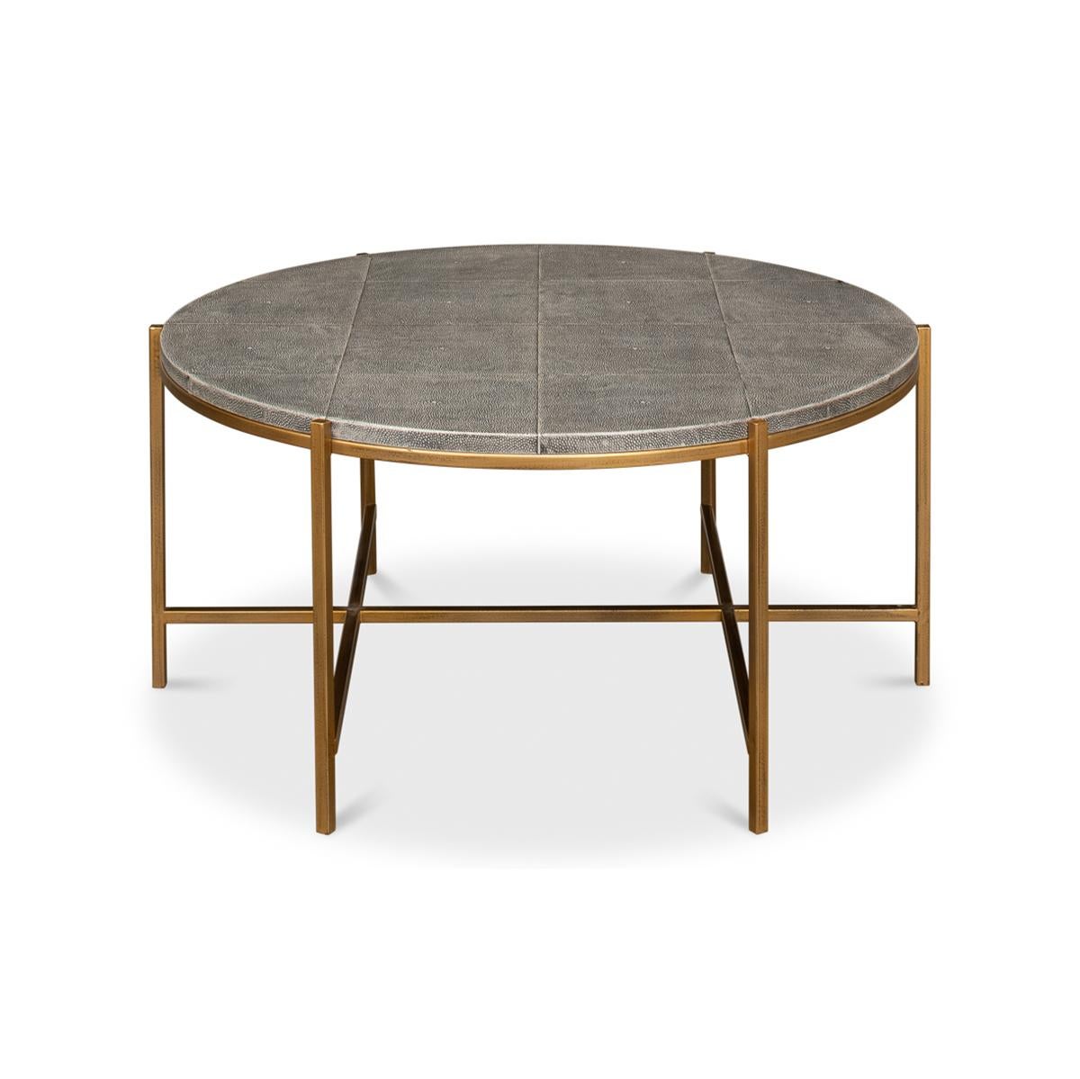 Mid century Round leather cocktail table with a shagreen embossed leather top in a geometric grid form above a gilded iron base with stretchers.

Dimensions: 34
