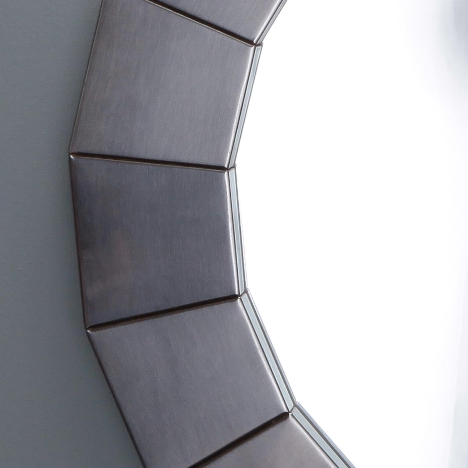 Round mirror with wide, sectioned frame of silver tone brushed aluminum, circa 1970s. Actual Mirror Size: 18.75” diameter. Unknown maker. Found in Belgium.