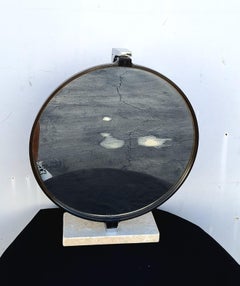 Mid Century round Plexiglas frame set on a base crafted from Carrara marble.
