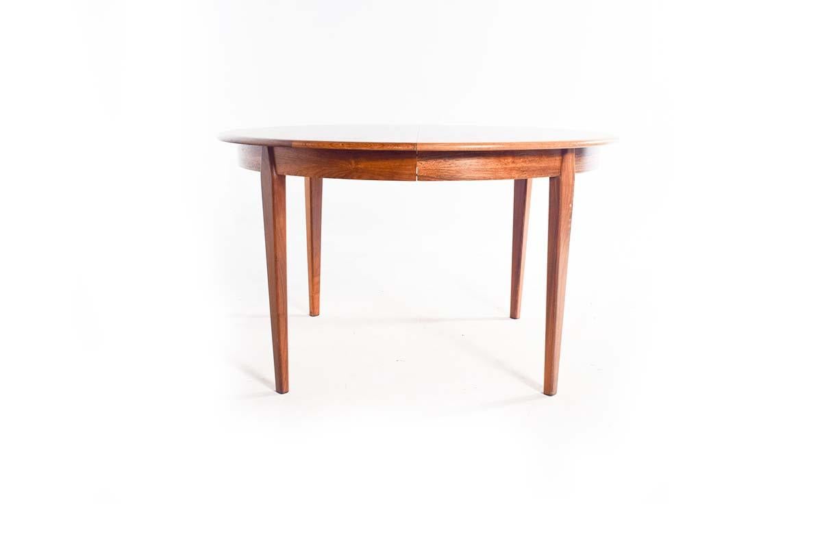 This exquisite dining table, crafted by H. Sigh & Sons from Denmark, embodies the timeless elegance of Scandinavian modern design. Made from luxurious rosewood, the table showcases the rich, natural grain patterns and deep, warm tones characteristic