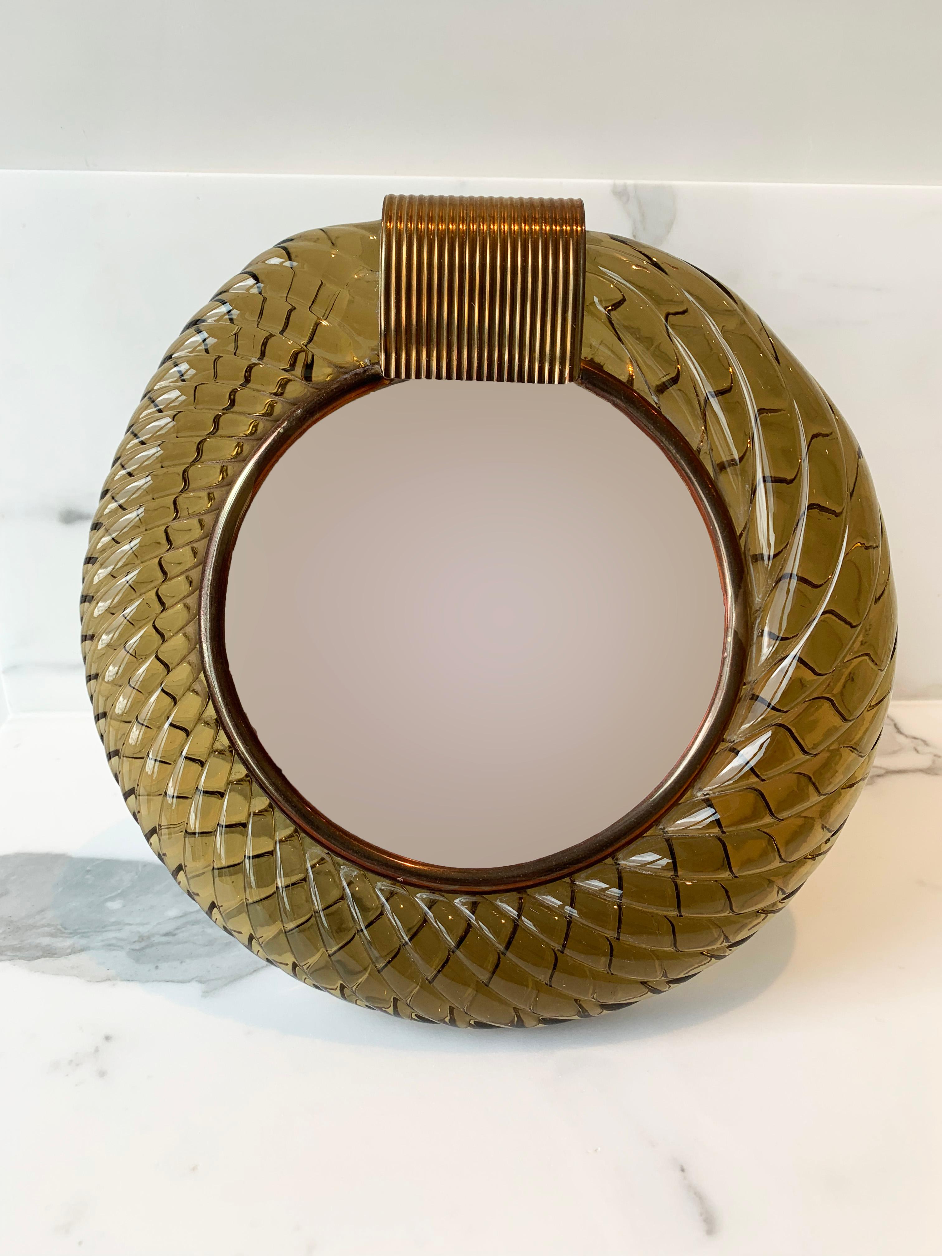 Circular Murano Glass ‘Torchon’ picture frame, by Seguso circa 1940s.

This chic and glamorous frame is comprised of a thick handmade Murano glass border; in a wonderfully deep hued amber glass with a slight tinge of bronze. The Murano glass has