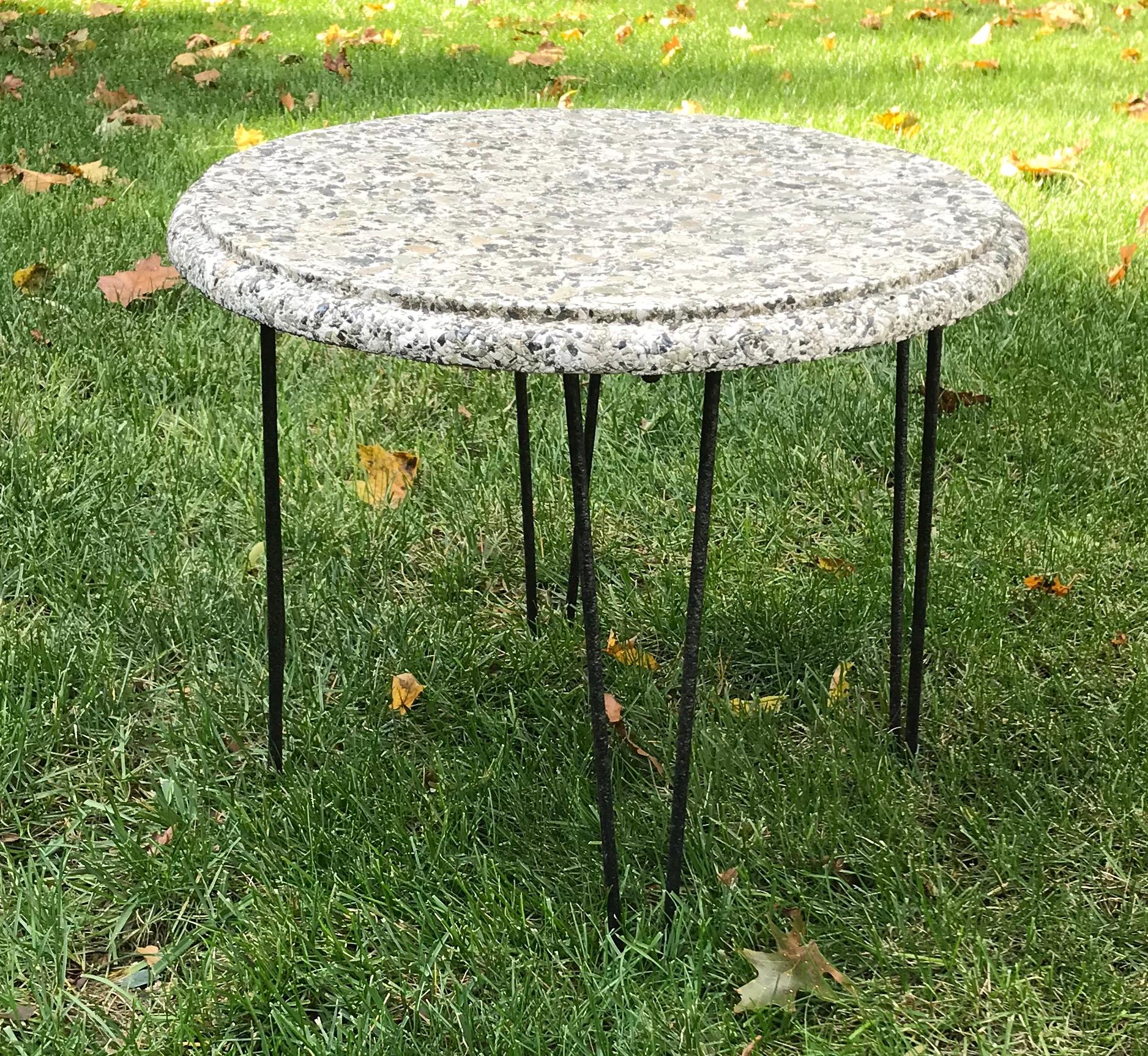 Cool small mid century stone top round side table with wrought iron hairpin legs, 1950s. Patio or poolside side table, can also be used as a small coffee table. One of the hairpin legs is slightly bent, hardly noticeable, please see photo.