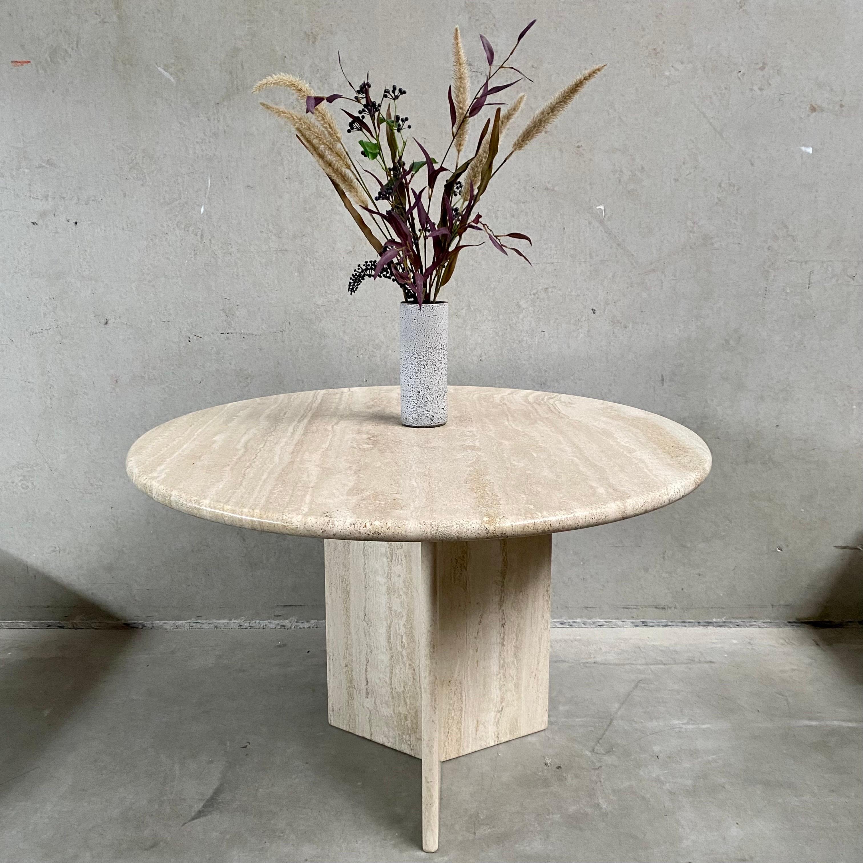 Introducing the ultimate statement piece for your high-end restaurant or luxurious dinner parties - the Mid-Century Round Travertine Dining Table from Italy, circa 1970s. This stunning piece exudes elegance and sophistication, and is sure to impress