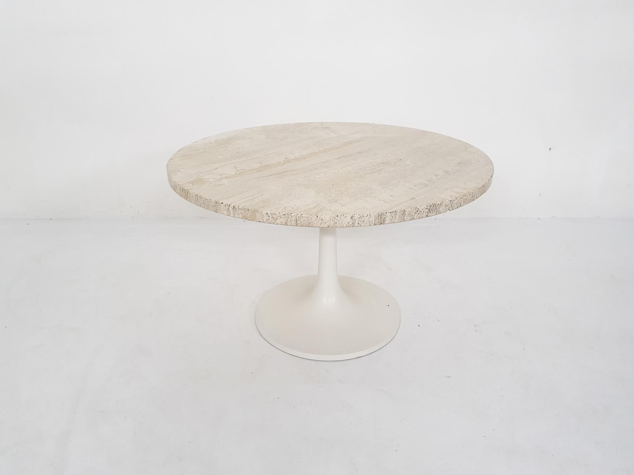 Round travertine side table on polyester tulip foot.