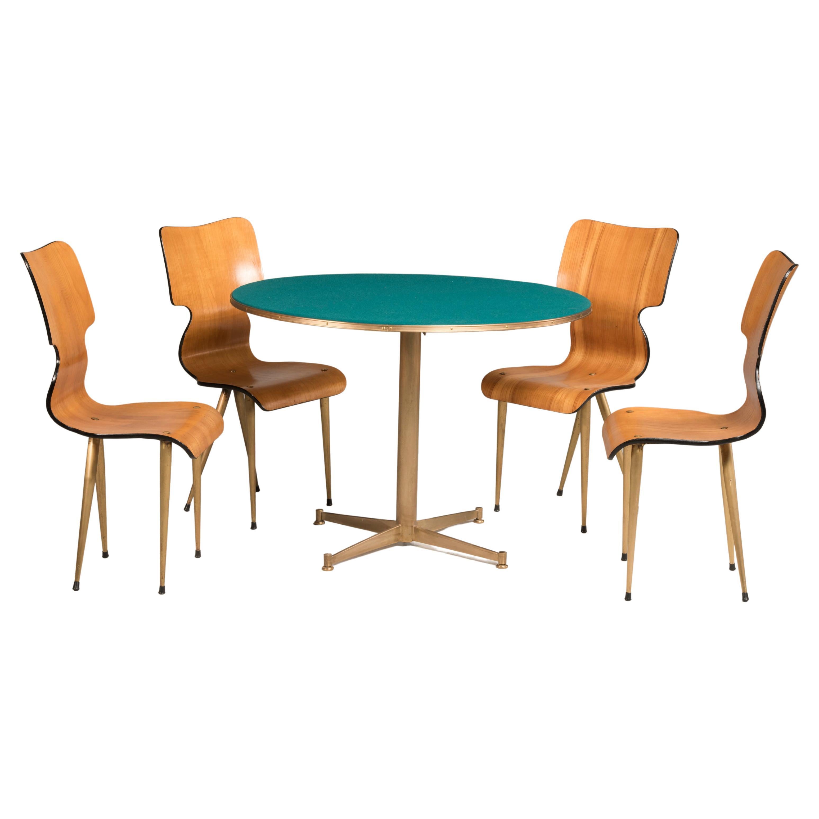 Mid Century Rounded Green fabric wood and brass legs game table and four chairs.
This set comes from Italy from 1950s period.
The brass base of table forms a cross. Chairs are made in pressed and shaped wood, black lined and have brass legs.
The