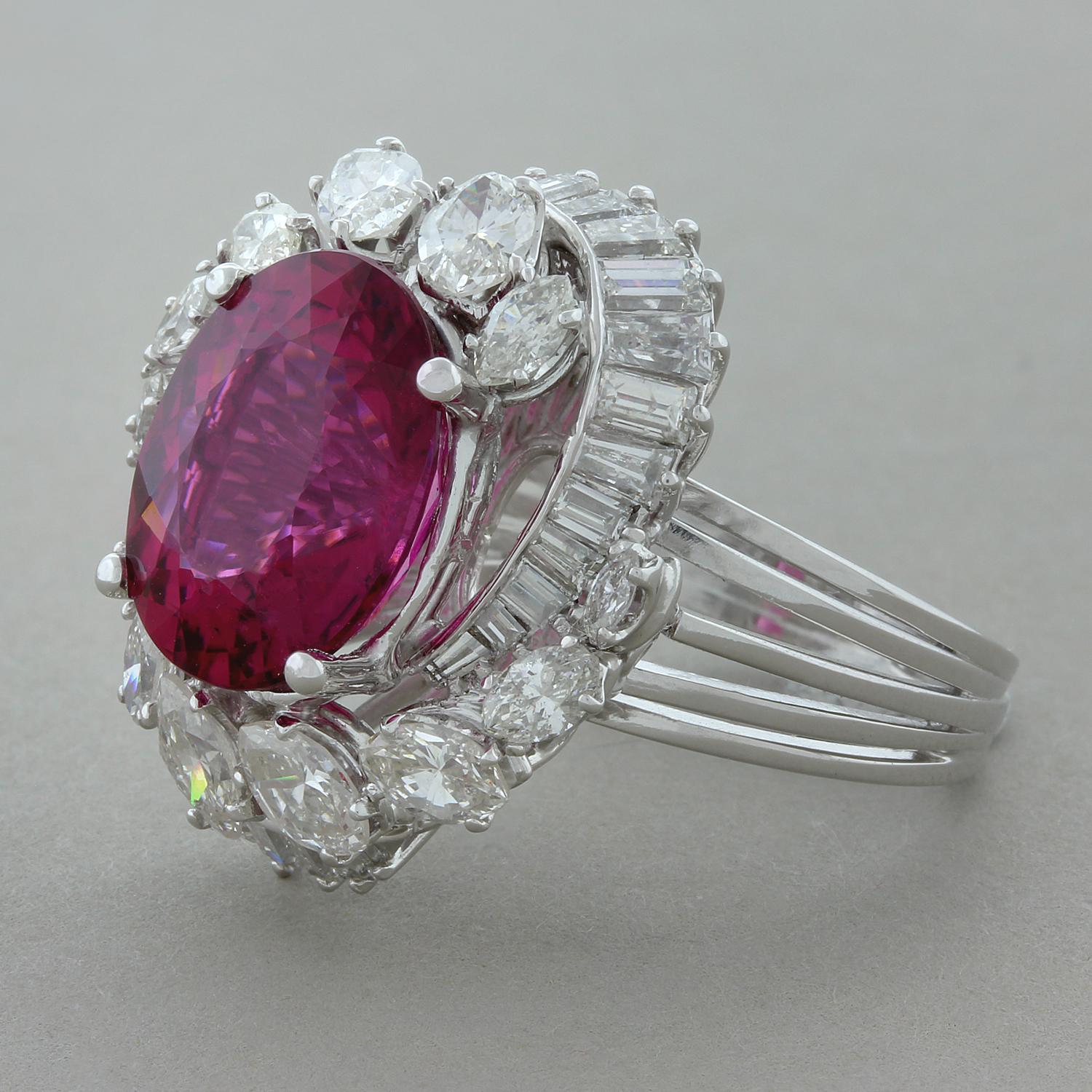 A gorgeous ring from the 1960’s featuring a 6.84 carat oval shaped royal red rubelite tourmaline. The rubelite is surrounded by 3.40 carats of marquise and baguette cut diamonds which spiral around the gemstone in a platinum setting. A classic