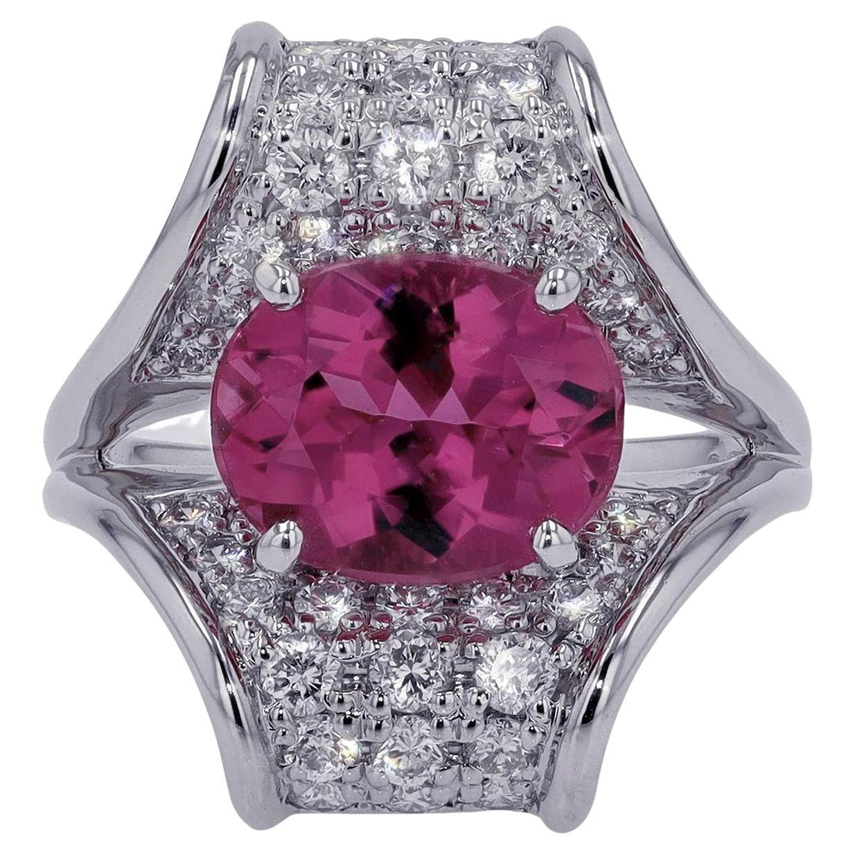 A bright and lively rubellite tourmaline commands the spotlight in this intriguing Mid Century cocktail ring. The platinum setting resembling a budding flower adorned with sparkling, pave' set diamonds can be worn as a dreamy gemstone engagement