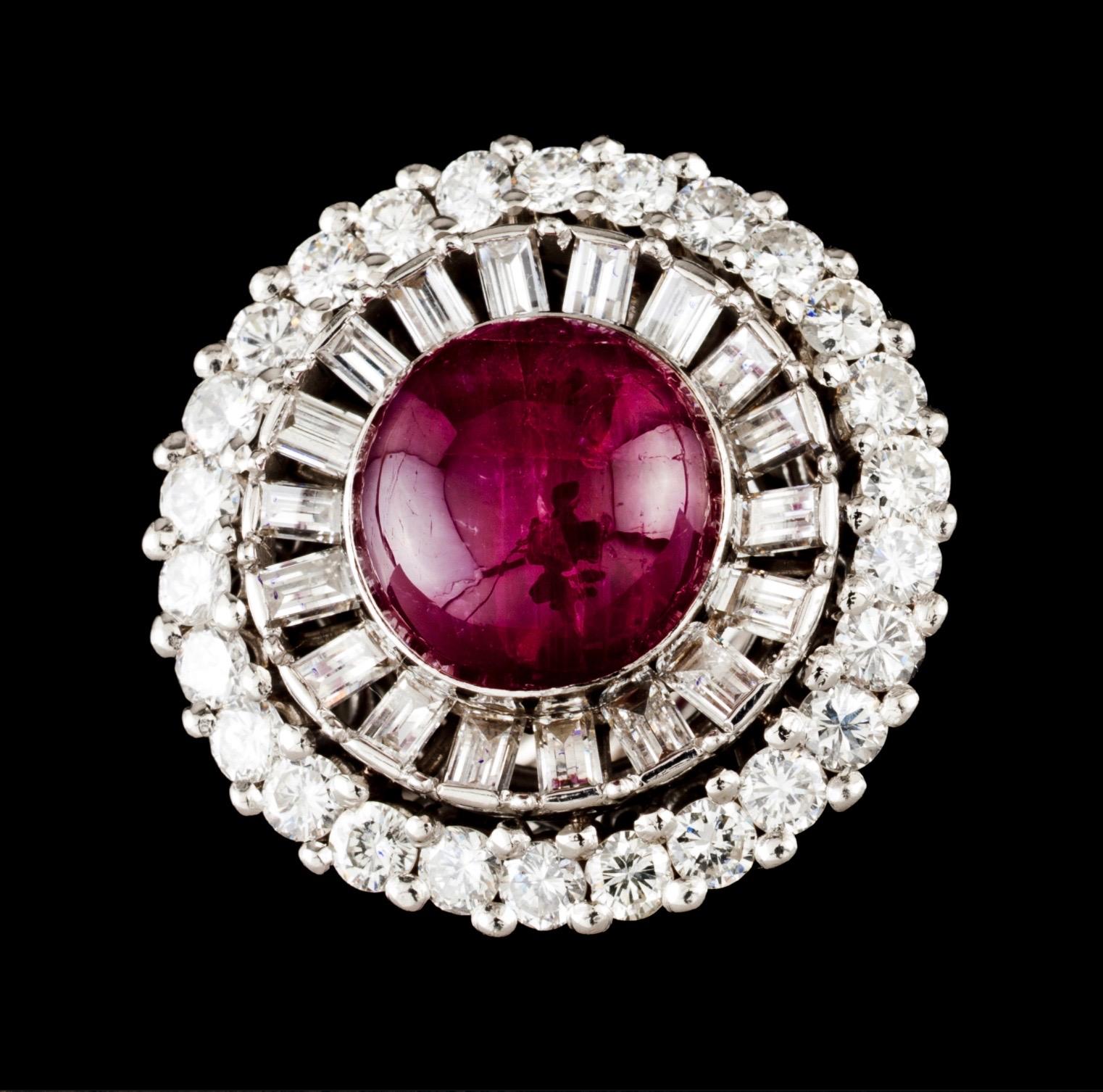 Mid-Century natural star ruby cabochon and diamond ballerina cocktail ring in platinum and white gold, Europe, 1950s/1960s. Of circular shape, this ring features a ruby cabochon bezel-set to the center, surrounded by a row of 18 channel-set