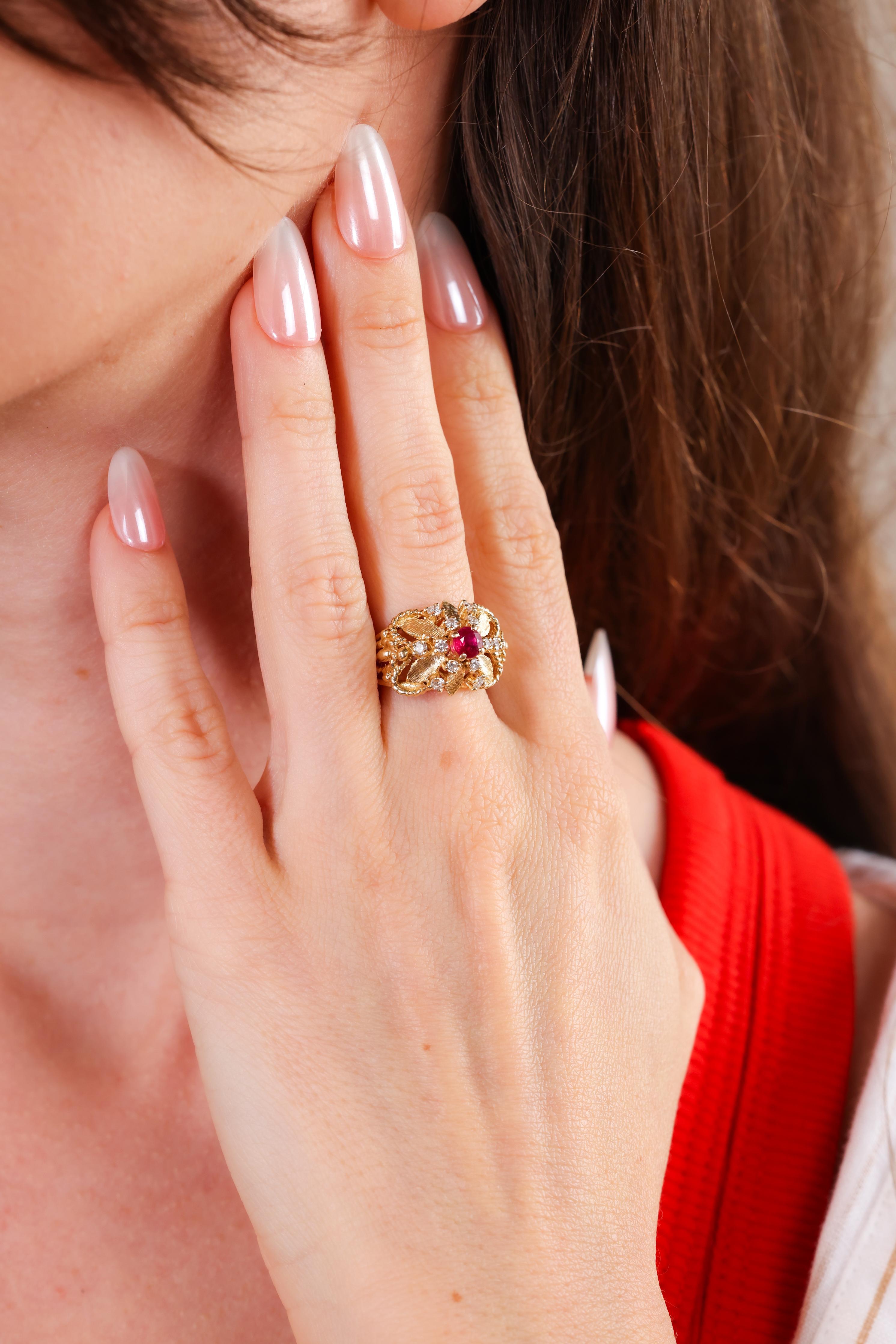 Center Stone: Ruby
Cut: Round
Weight: 0.50 carats approximately 
Accent Stone: 12 diamonds
Cut: Round brilliant
Weight: 0.35 carats approximately 
Color: J-K 
Clarity: SI
Metal: 14k yellow gold 
Circa: 1960s
Hallmarks: Purity marks
Size: 6-1/4 and