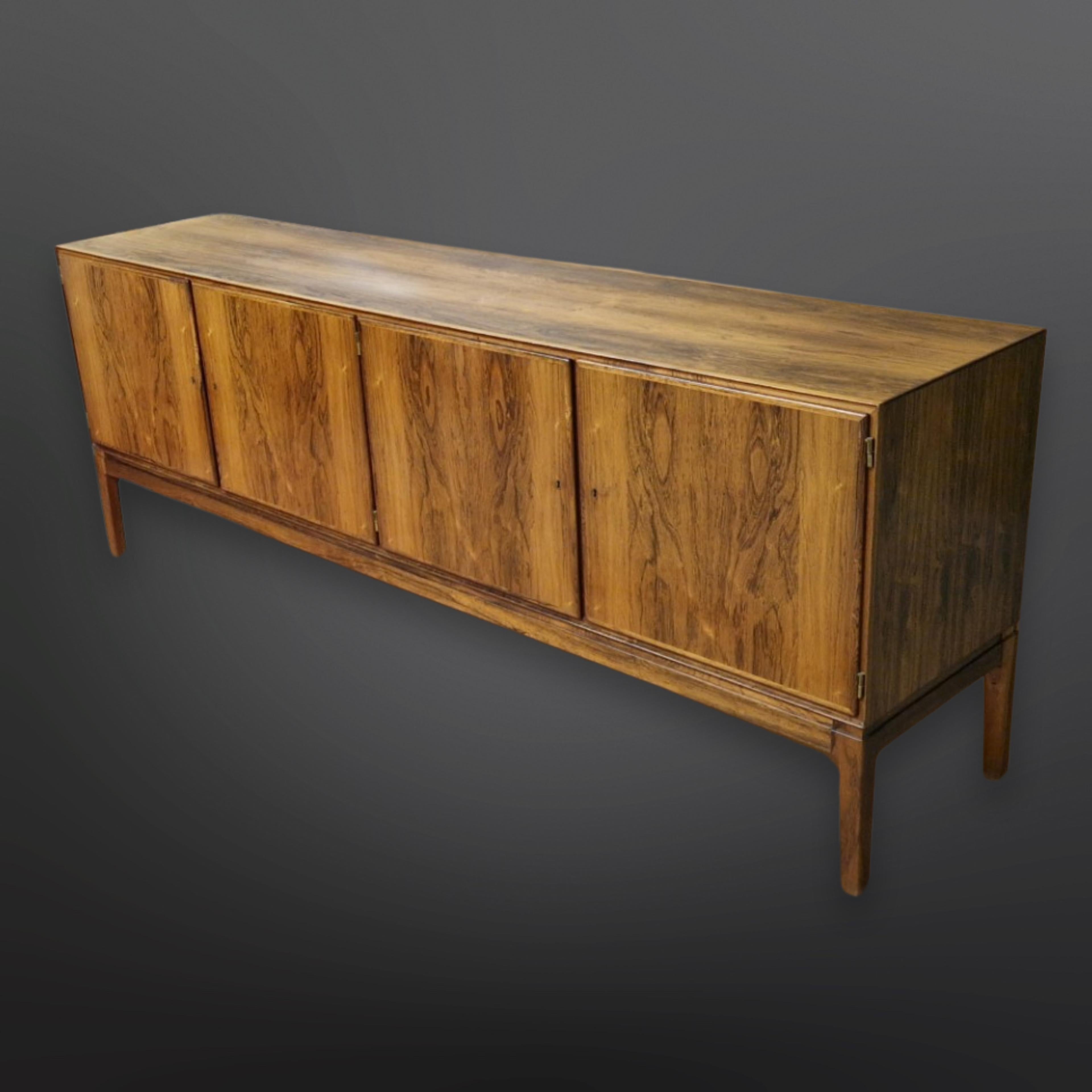 Exclusive sideboard in hardwood with 2 double doors. 
This exceptional piece is part of the Rungstedlund series. 

Hinges and keys in brass, veneered inside out with beautiful trays. It can be used as room divider due to veneered back. 

Design by