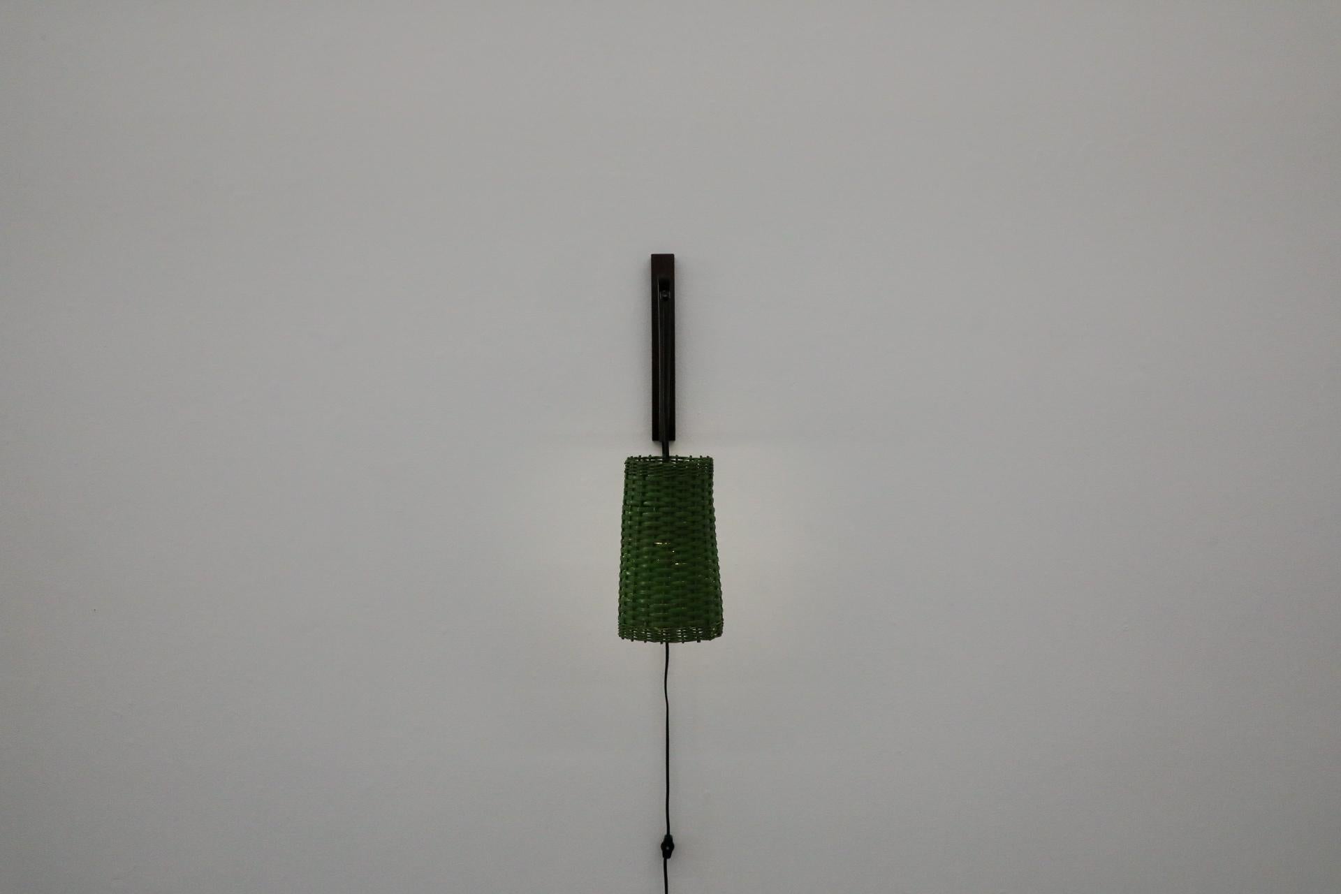 Lovely, Mid-Century wall light in the style of German industrial designer Rupprecht Skrip. The natural Wenge wood and rattan elements of this one-of-a-kind fishing pole light with a green rattan shade add a touch of natural aesthetics to the space,