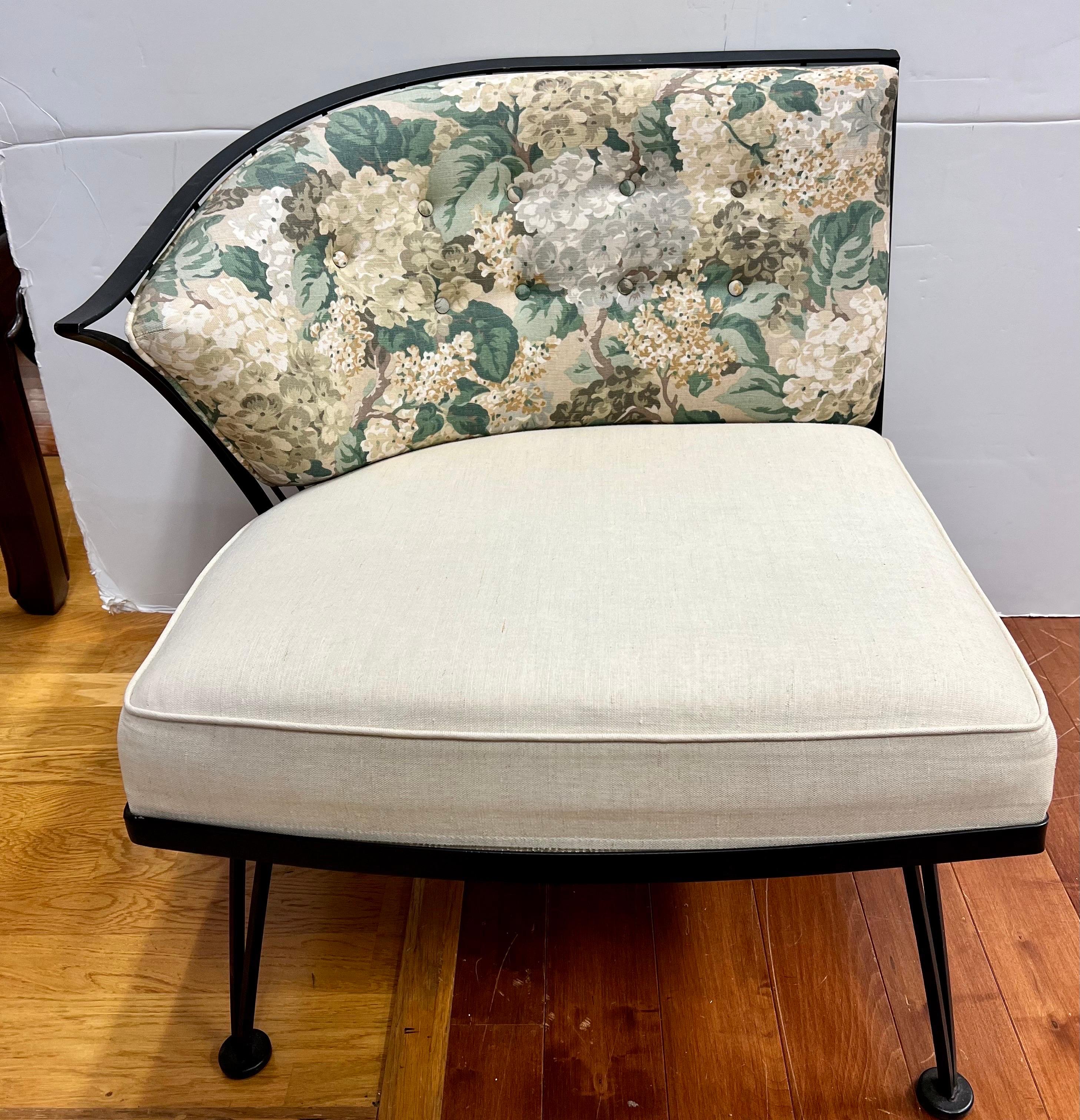Mid century Woodard has three sections and is upholstered with a beige linen seat with coordinating green leaf pattern back cushions with button tufting. This has been upholstered for interior use. It can be placed into several formations (as a