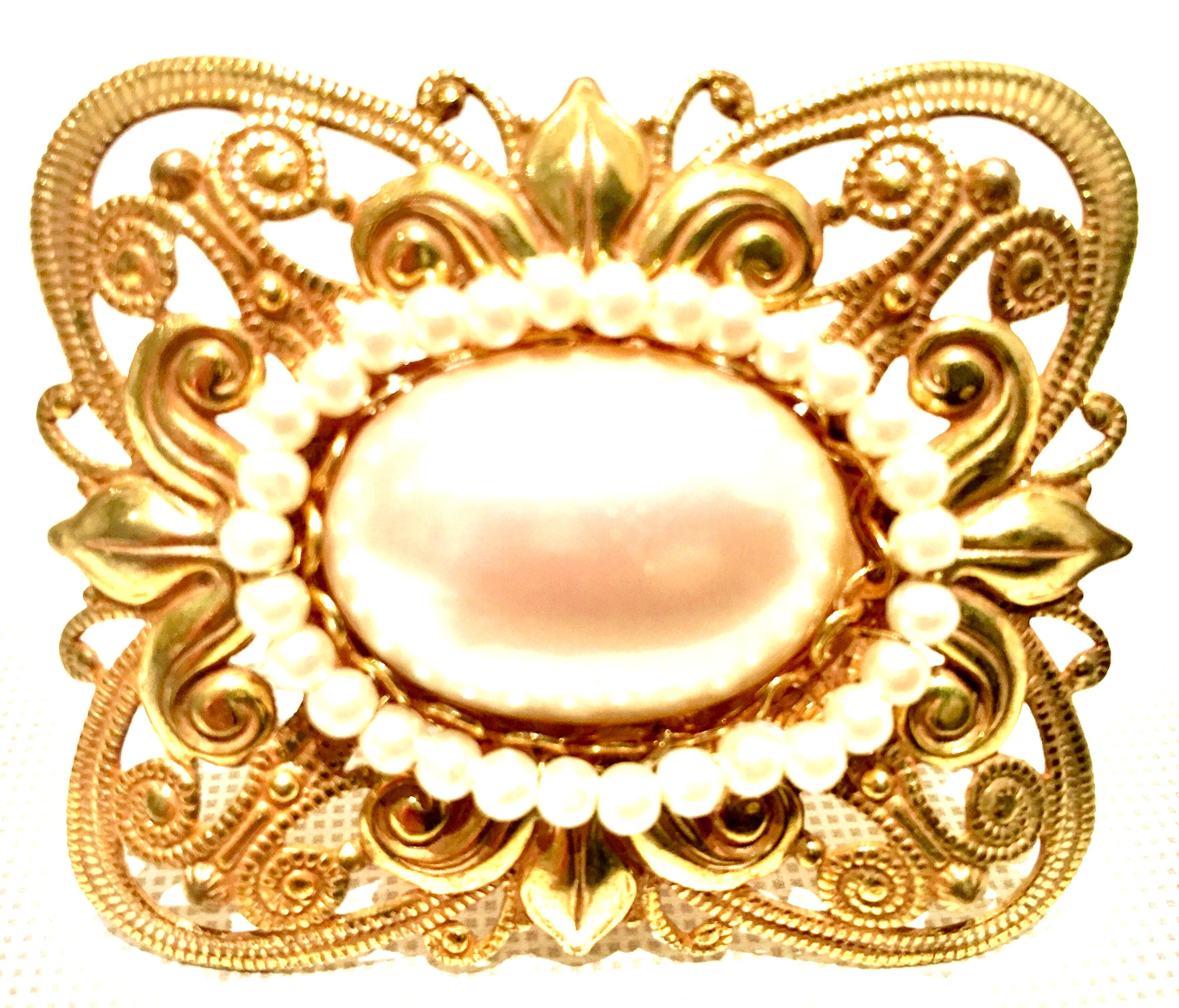 Mid-Century Miriam Haskell Astract Russian Gold Fligree Abstract Butterfly Brooch-Signed. This rare and signed brooch features, a large central oval faux pearl surround by round faux pearl beads. Singed on the underside, Miriam Haskell. Measures: