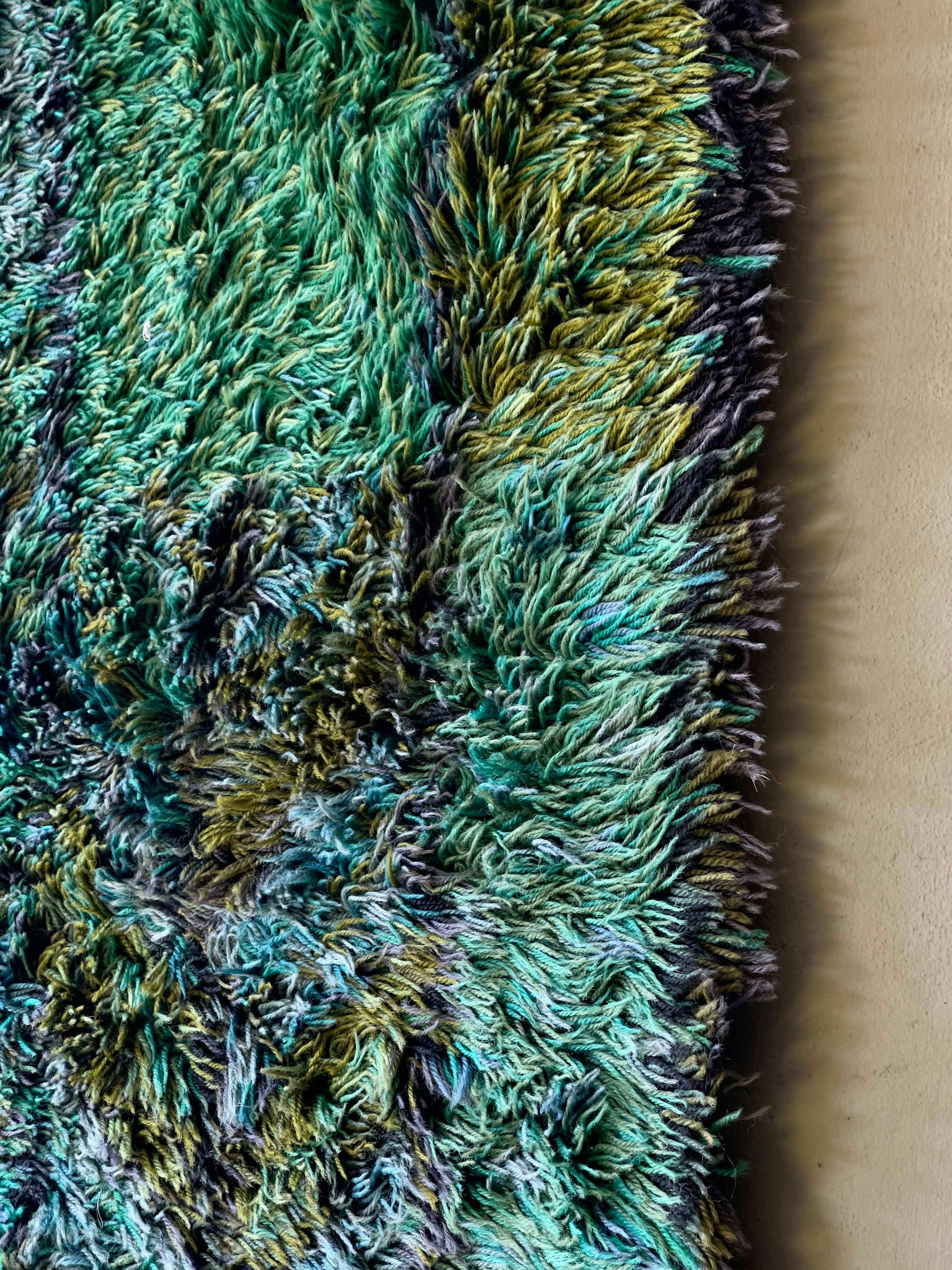 Vintage Swedish green and blue rya rug by Marianne Richter for Ötergyllen rya, 1960s. Handmade by Rya weaving technique from 100% wool.

Swedish textile artist Marianne Richter is internationally revered for her range of extraordinary rugs,
