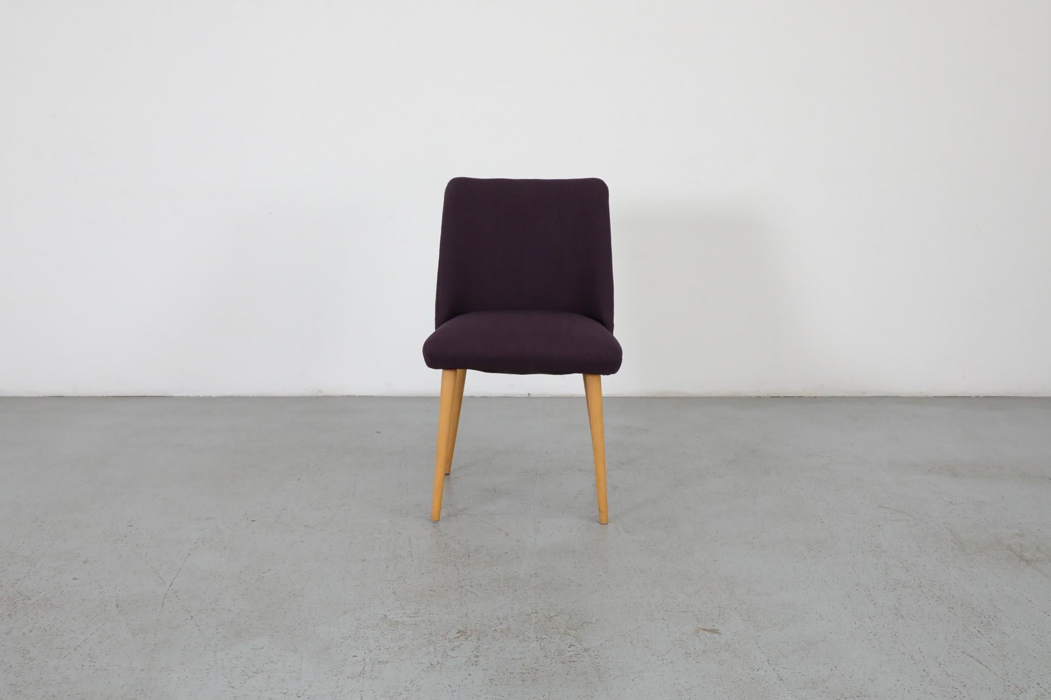 Single Saarinen style dining or cocktail chair newly reupholstered in purple fabric with natural birch tapered legs. In otherwise original condition with visible wear consistent with its age and use. Other similar chairs available, listed separately.