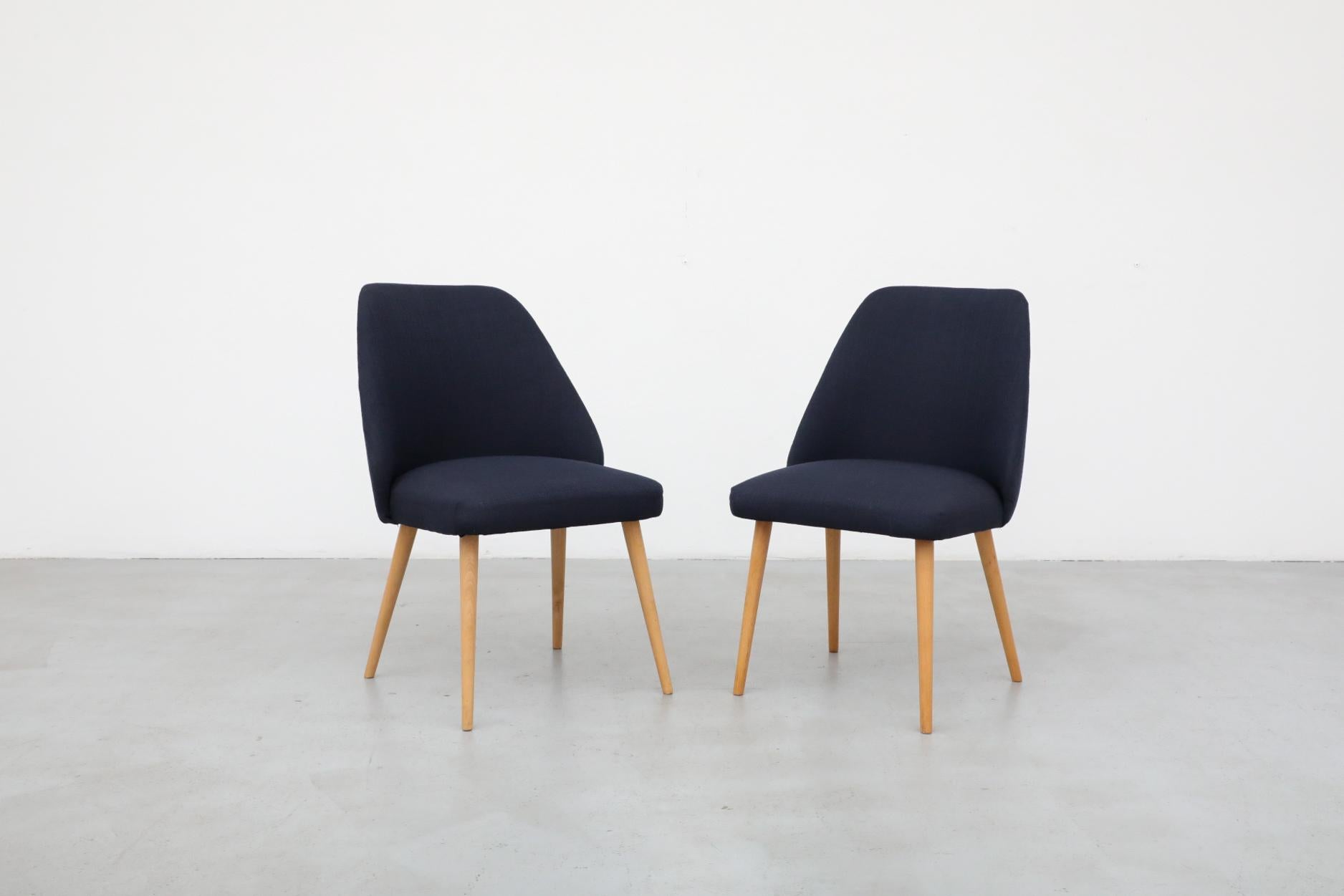 Mid-Century Saarinen style accent or cocktail chair in newer navy fabric with natural birch tapered legs. In otherwise original condition with some visible wear consistent with its age and use. Many similar chairs available in varying sizes, shapes