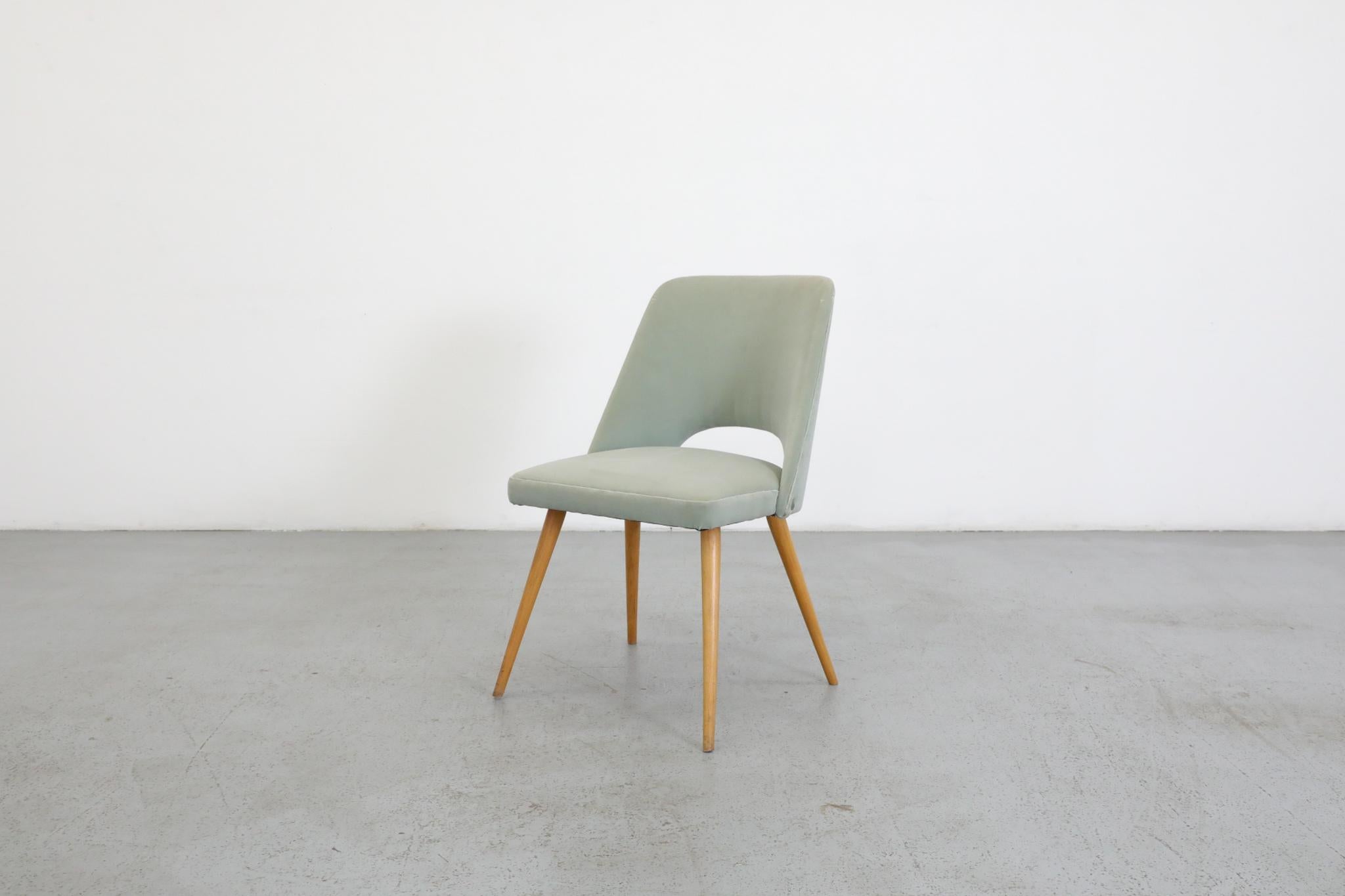 Mid-Century dining or cocktail chair. Designed in a style that's very reminiscent of Finnish designing great Eero Saarinen. The chair has handsomely tapered blonde wood legs and has been newly upholstered in a lovely light teal velvet. In good