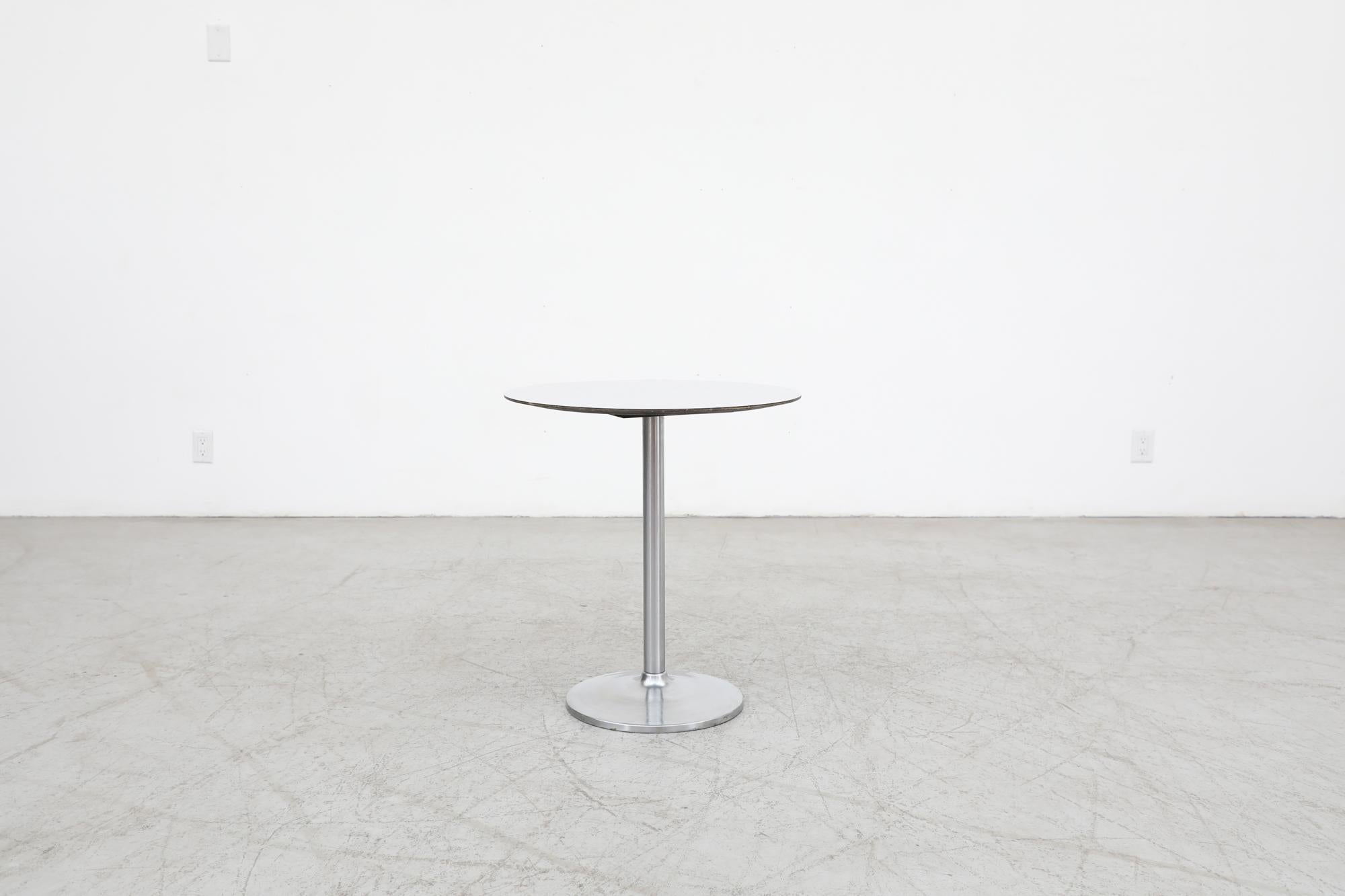 Dutch Mid-Century pedestal side table with attractively sleek steel base and a gray laminate plywood top. Reminiscent of the work of Eero Saarinen. The table is in original condition with some visible signs of wear consistent with its age and use.