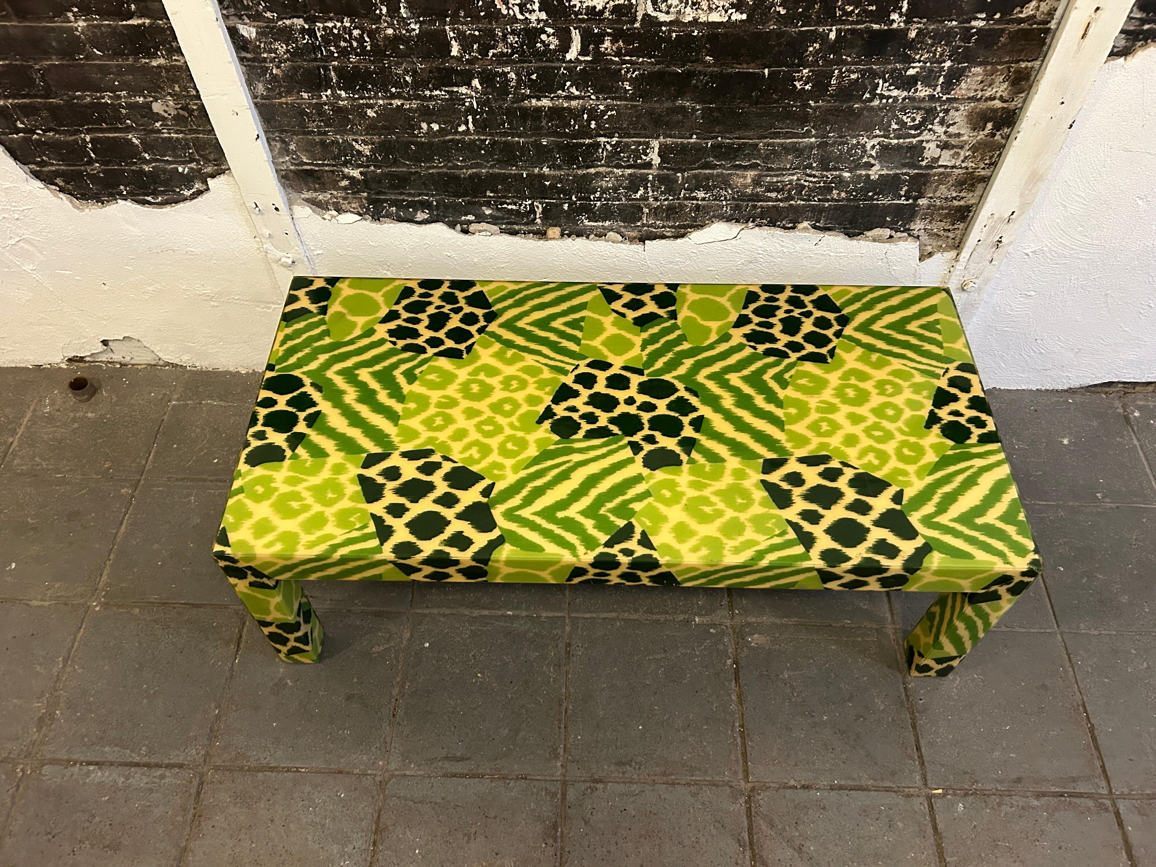 Mid Century Safari Print Resin Parsons Coffee Table style of Karl springer or Milo Baughman. A designer coffee or cocktail table. Mid Century Post Modern featuring an eye catching safari design fabric Print in Greens, with leopard, tiger, zebra,