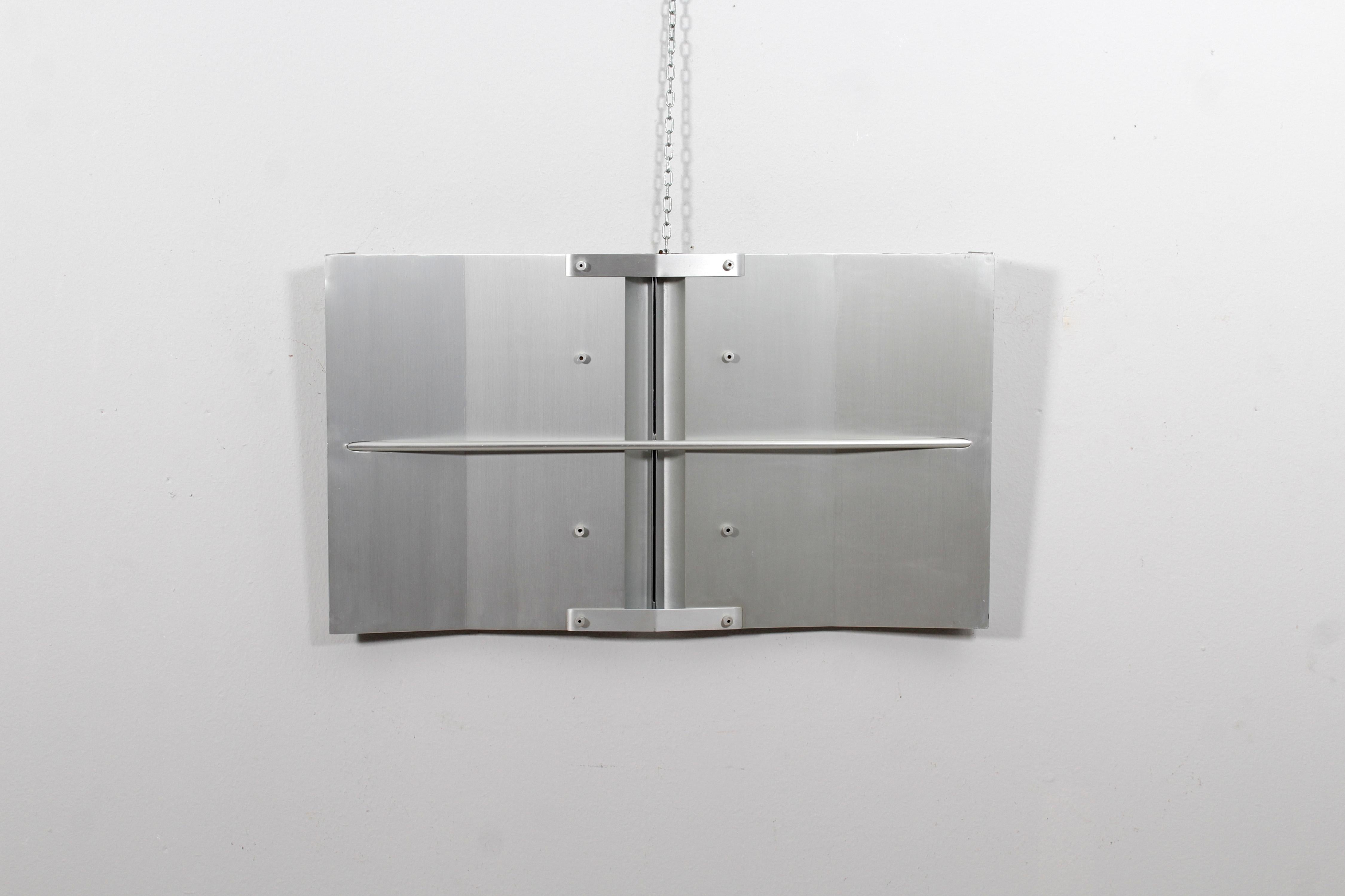 Rectangular panel sculpture with geometric elements in aluminum on a wooden support. work entitled 