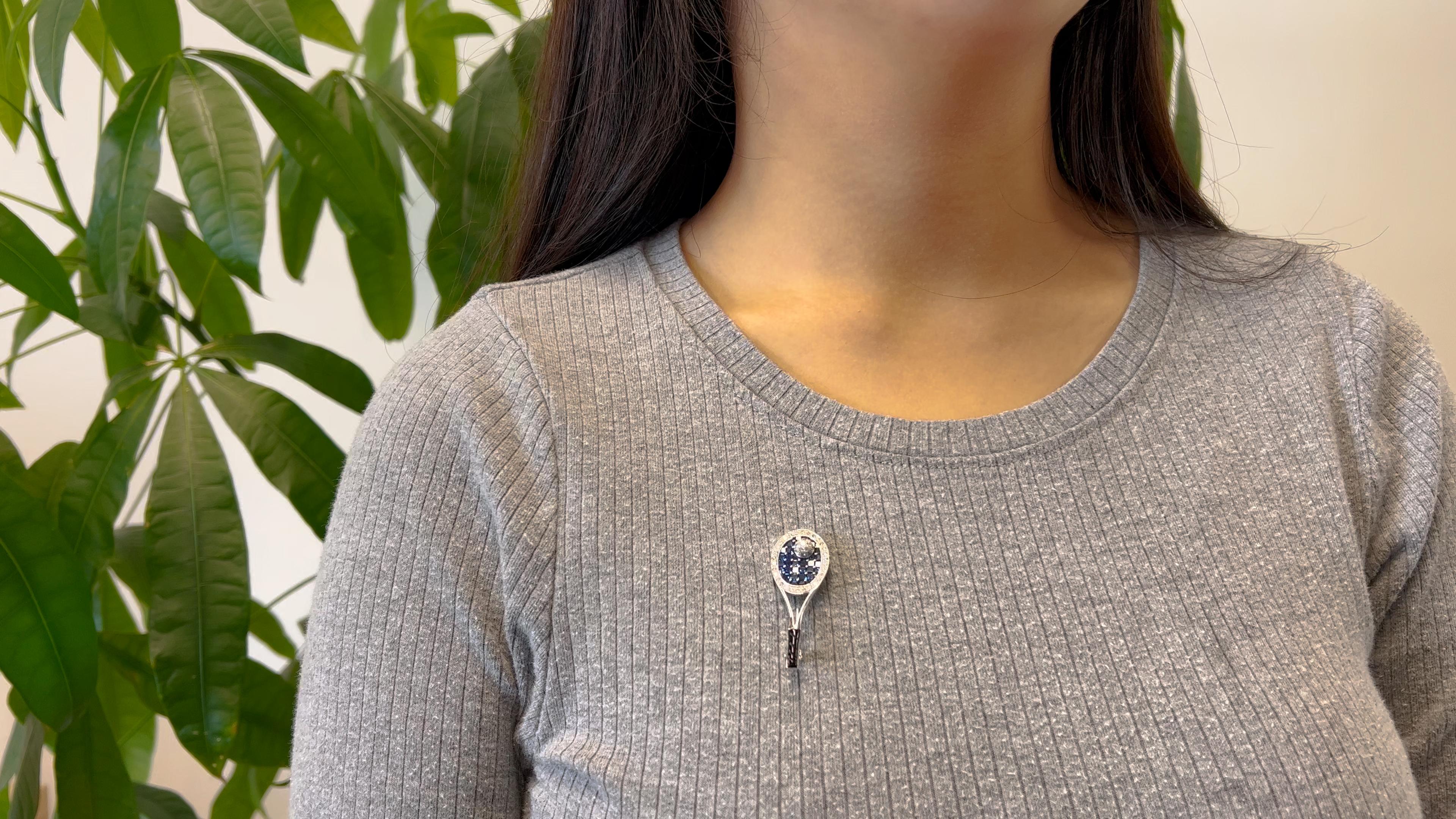 One Mid Century Sapphire Diamond 18k White Gold Tennis Racket Brooch. Featuring 42 square and calibré step cut sapphires with a total weight of approximately 1.90 carats. Accented by 45 round brilliant cut diamonds with a total weight of