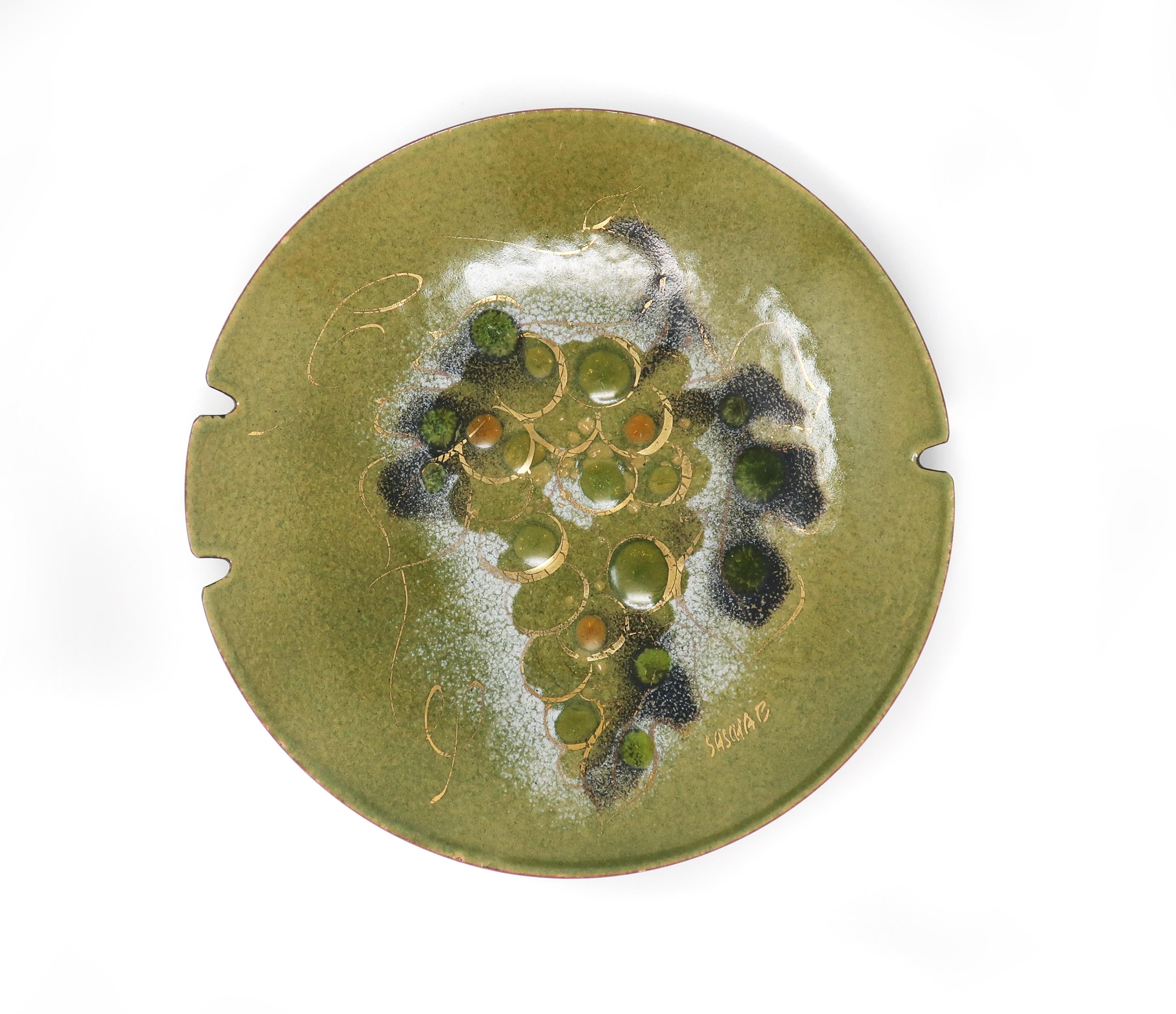 A fantastic example of California artist Sascha Brastoff’s Mid-Century Modern enamel on copper work. This ashtray features a bunch of grapes and leaves in greens, gold, orange, and dark grey. In excellent vintage condition and signed on front and