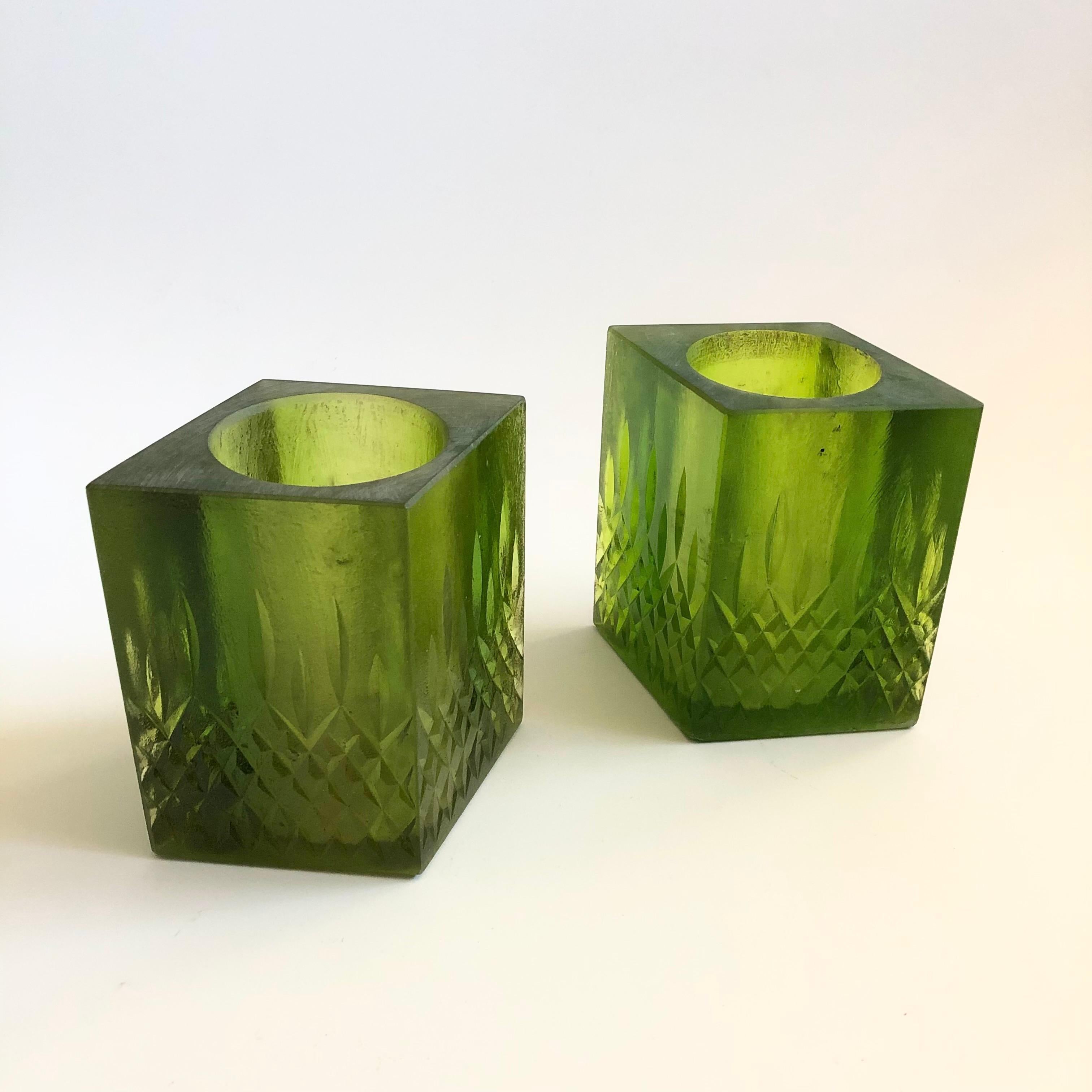 A pair of mid century vessels to use as a candle holders or vases. Made by Sascha Brastoff out of green textured resin. Signed on the bases.

