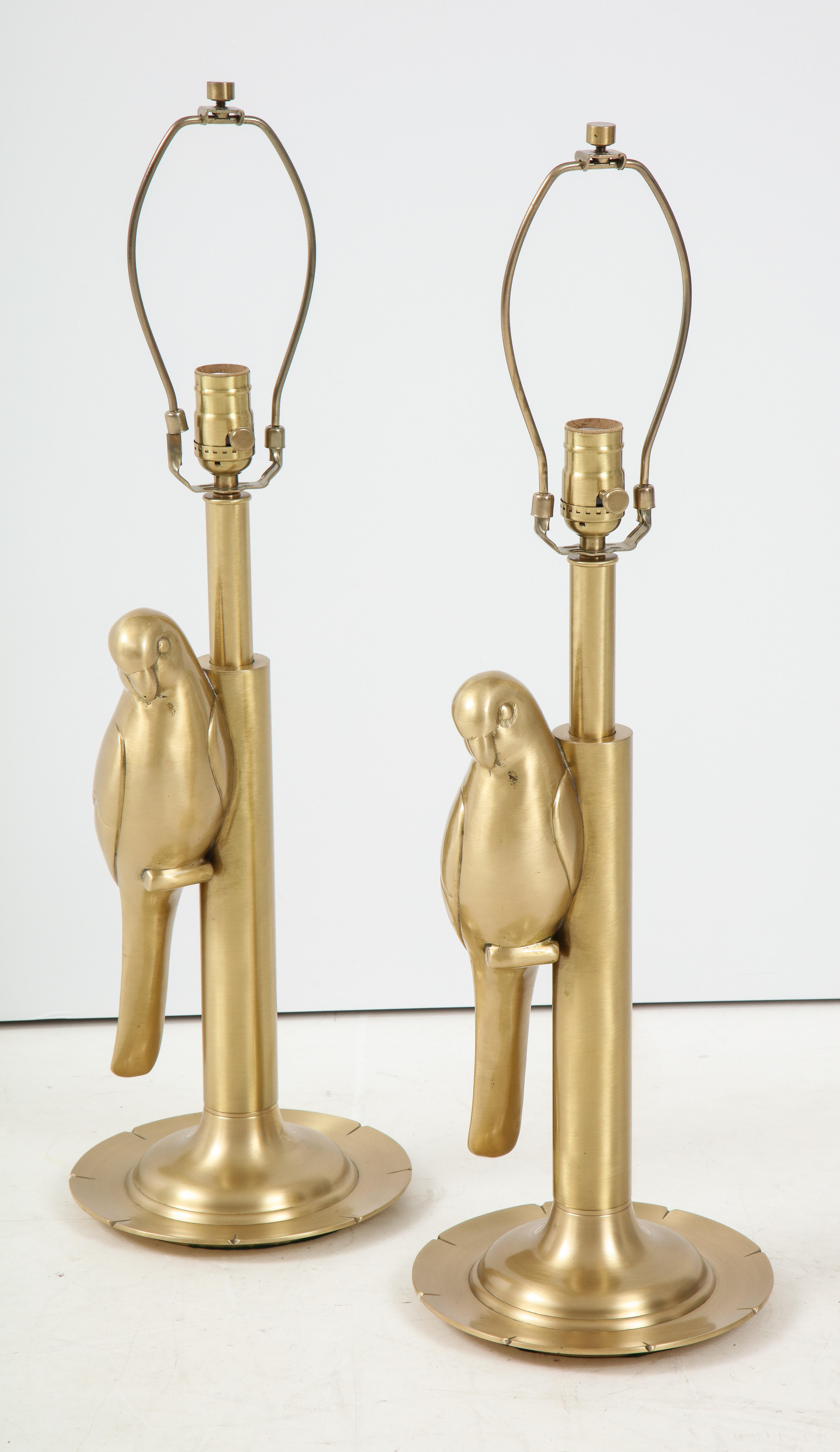Exquisite pair of heavy construction satin brass perched parrots. Rewired for use in the USA using silk cords, new sockets.