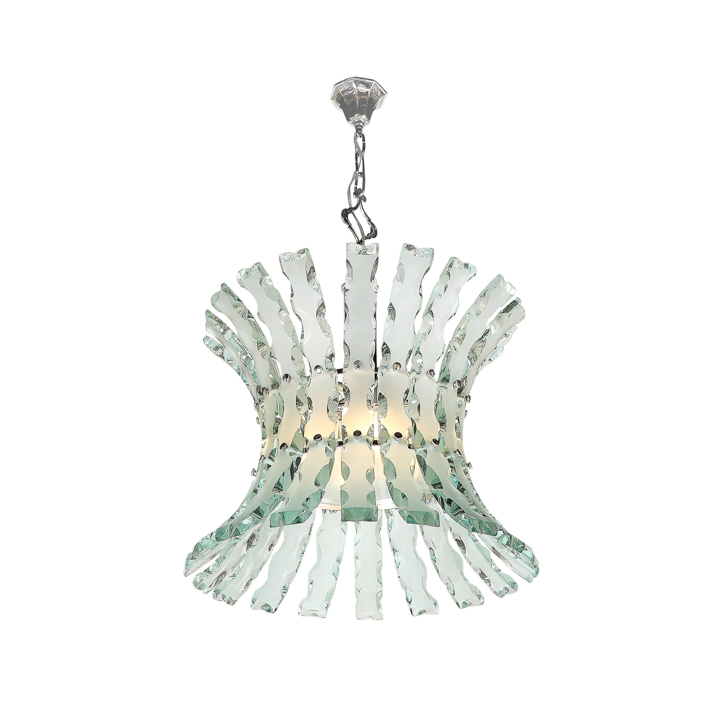 This unique and strikingly elegant Pair of Mid-Century Modernist Scalloped Verde Nilo Glass Chandeliers by Quattro Zero for Fontana Arte originates from Italy, Circa 1960. They feature large Verde Nilo curved glass shades with precisely executed and