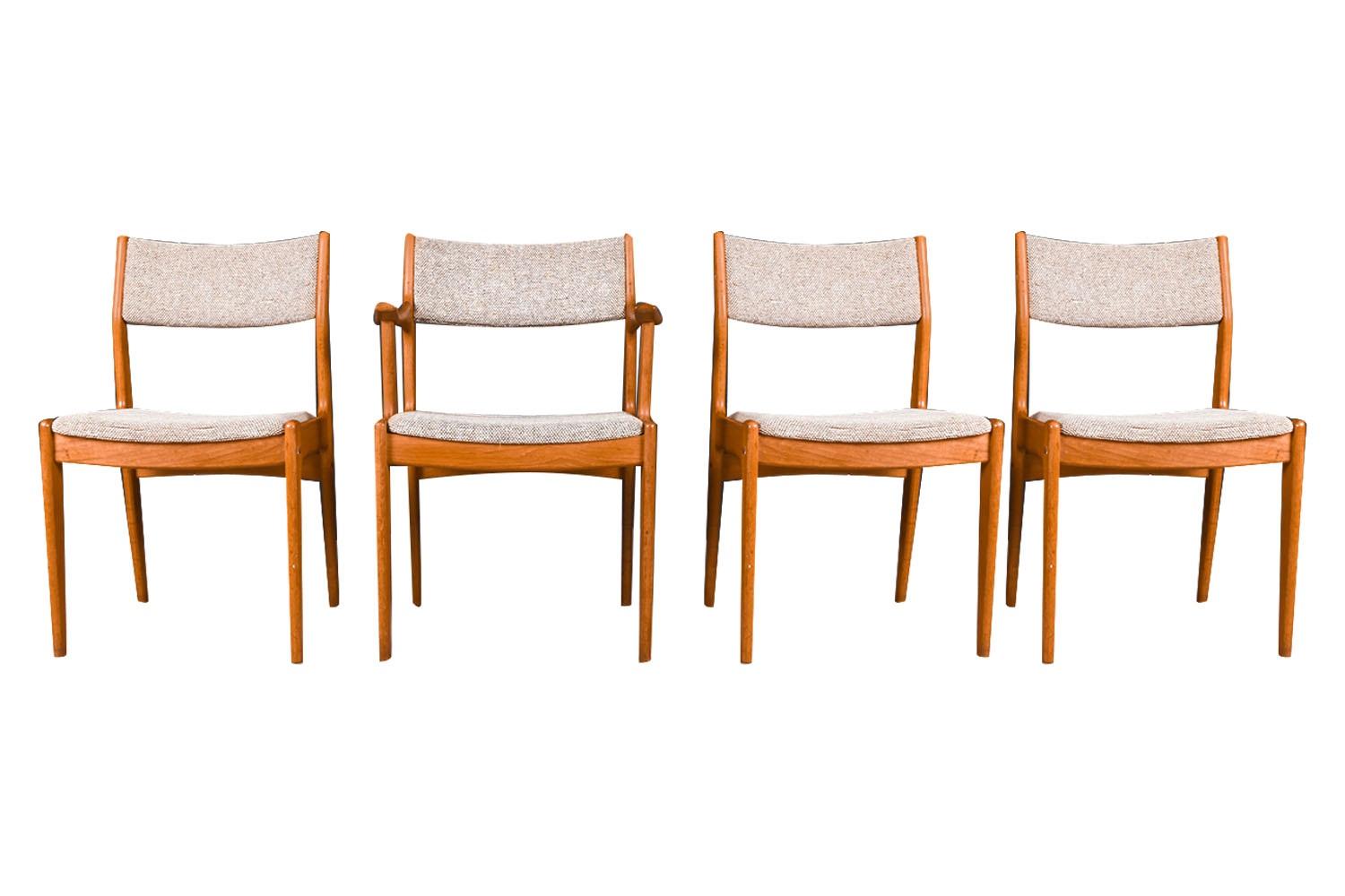 A set of four, extremely sought after, gorgeous 1960s, modern teak side/dining chairs by the Scandinavia Woodworks Co., made in Singapore. Featuring a full matching set of four, one of which has arms, each remains in original condition throughout.