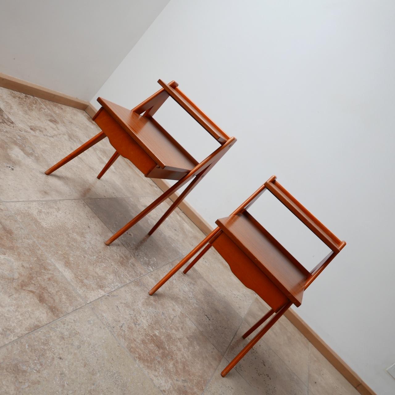 A pair of midcentury Scandinavian bedside tables.

Well designed angular form.

Two-tier shelves and single drawer to each.

Generally good condition, some wear consistent with age.

Dimensions: 39 W x 58 H x 42 D in cm.


  