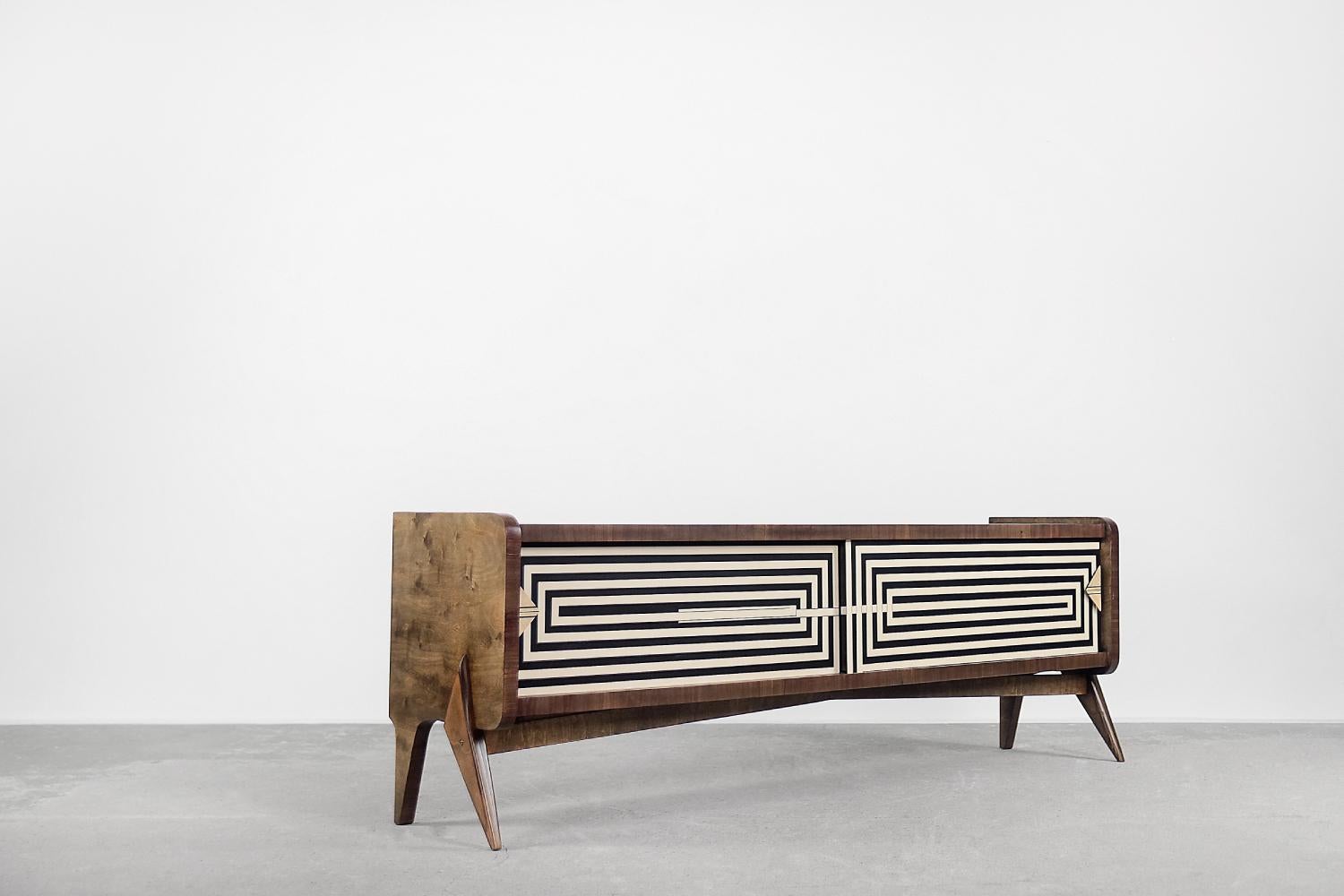 This modernist sideboard was produced in Scandinavia during the 1960s. It was finished with birch wood with irregular, strong graining with visible swirls. The wood is finished in a warm, brown color. The sideboard has a pair of sliding doors with