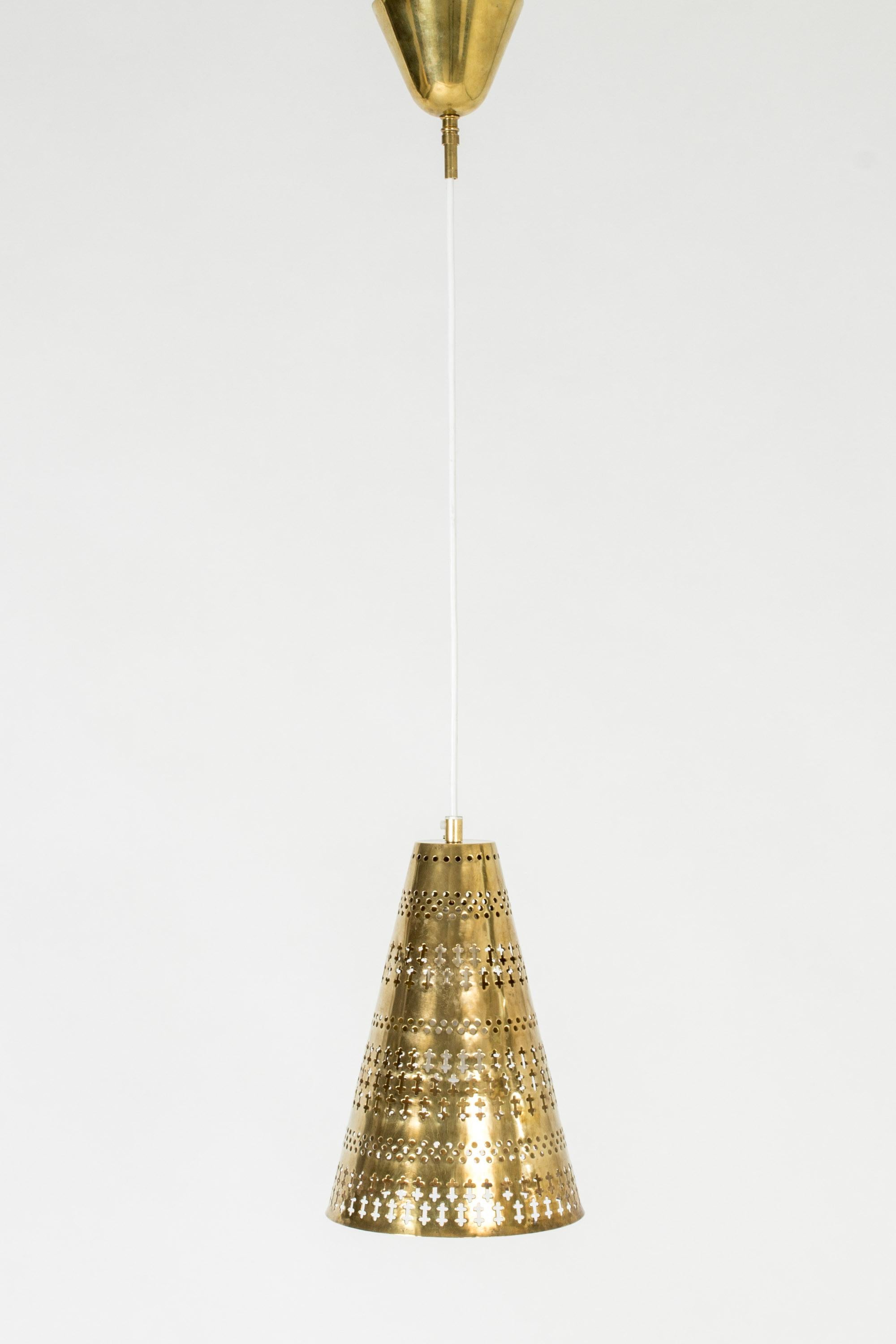 Lovley brass ceiling lamp by Hans Bergström, in a conical form. Perforated with a beautiful pattern of holes and graphic shapes, making it glow like a piece of art in the dark.

Hans Bergström was the owner and creative director of the lighting