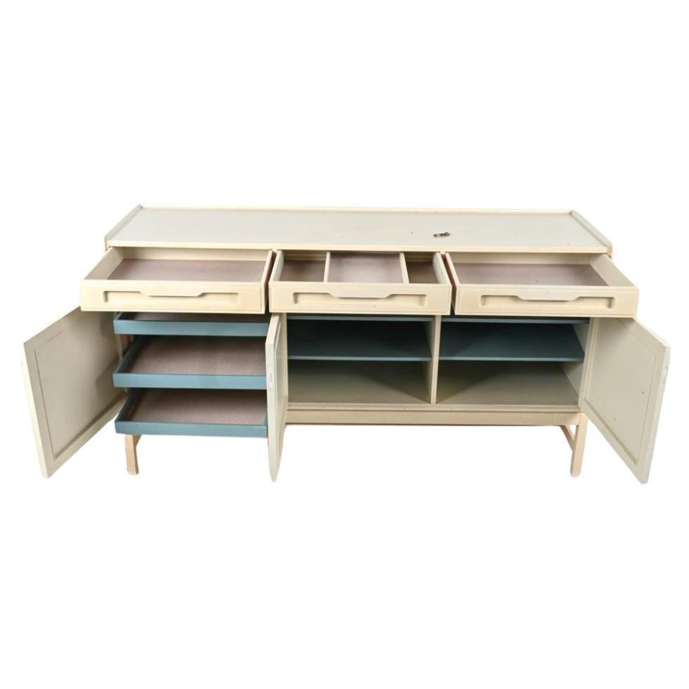 Scandinavian Danish 3 door painted credenza or sideboard. Has 3 top drawers with 3 lower doors with Key. Behind doors are 3 flat drawers and 4 adjustable shelves. All solid Oak custom painted in a light taupe color with light blue drawers and