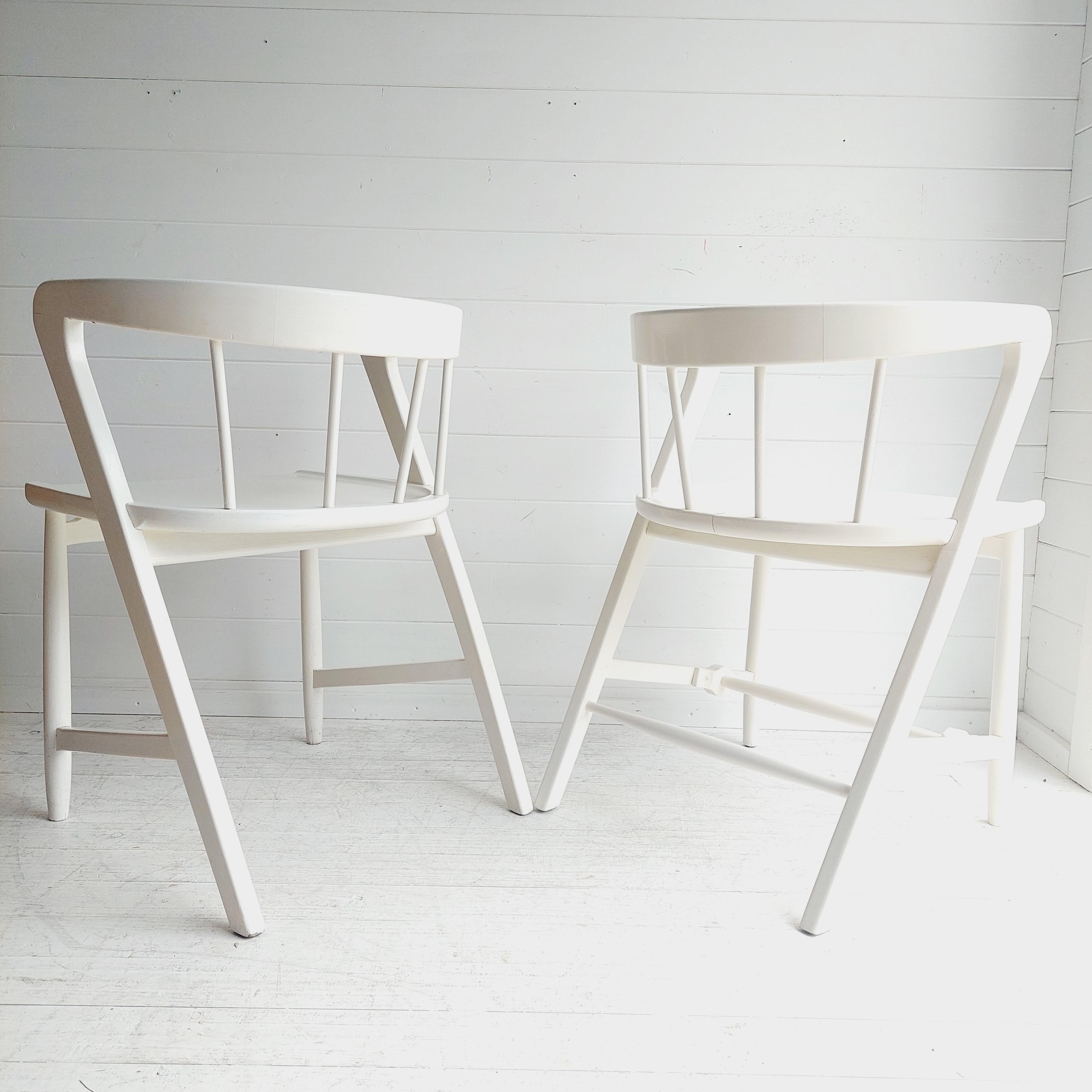 Stunning most probably Greaves and Thomas  dining chairs.
Set of 2
Manufactured by Maple and Co
Scandinavian look in the style of  the ‘put-u-up’ range
1960s 

Attractive curved backs and angled legs
spindle back chair inspired by the Windsor