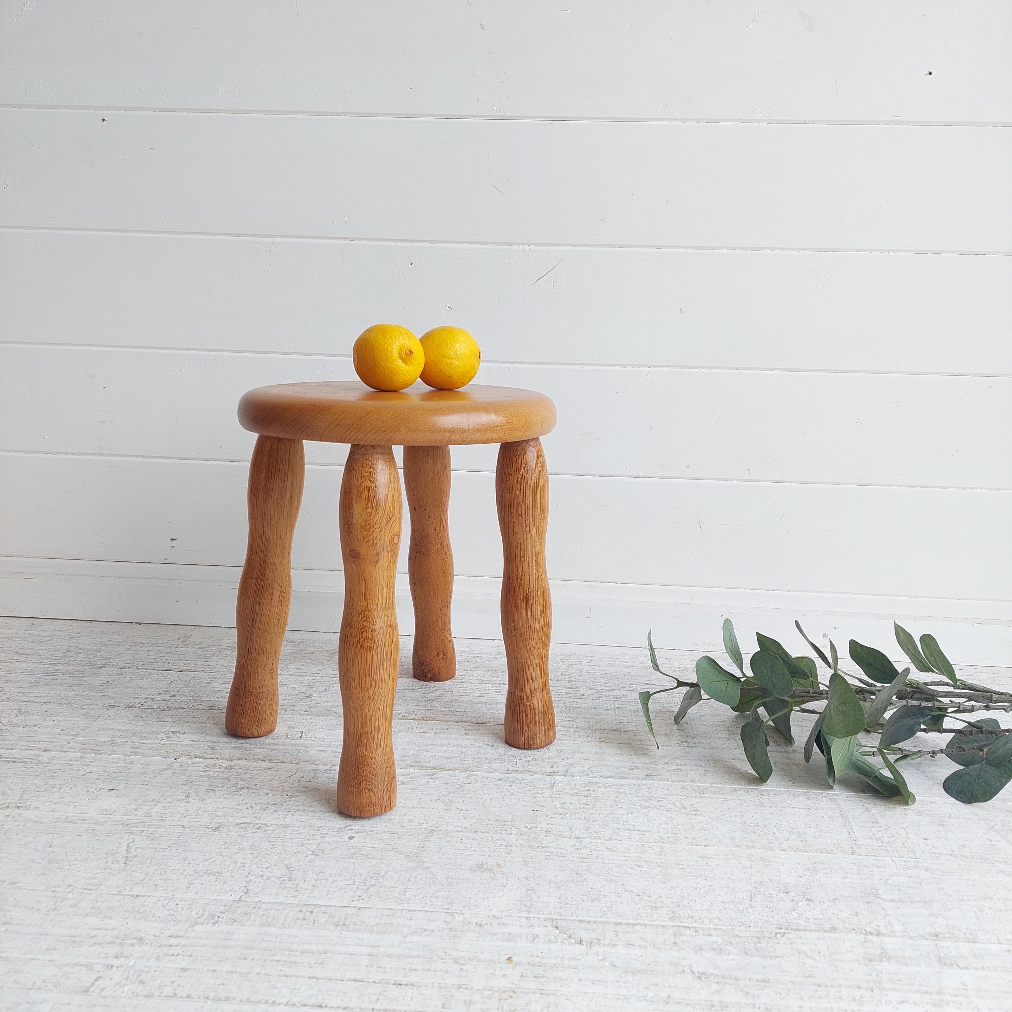 A delightful Elm milking stool 
Gorgeous carved bobbin legs
A lovely Scandinavian Mid Century Elm stool.
Probably from the 60s

Solid top and legs
With marvelous elm grain.
Having wavy bobbin legs.
Seat with round shape
Four legged stool

A great