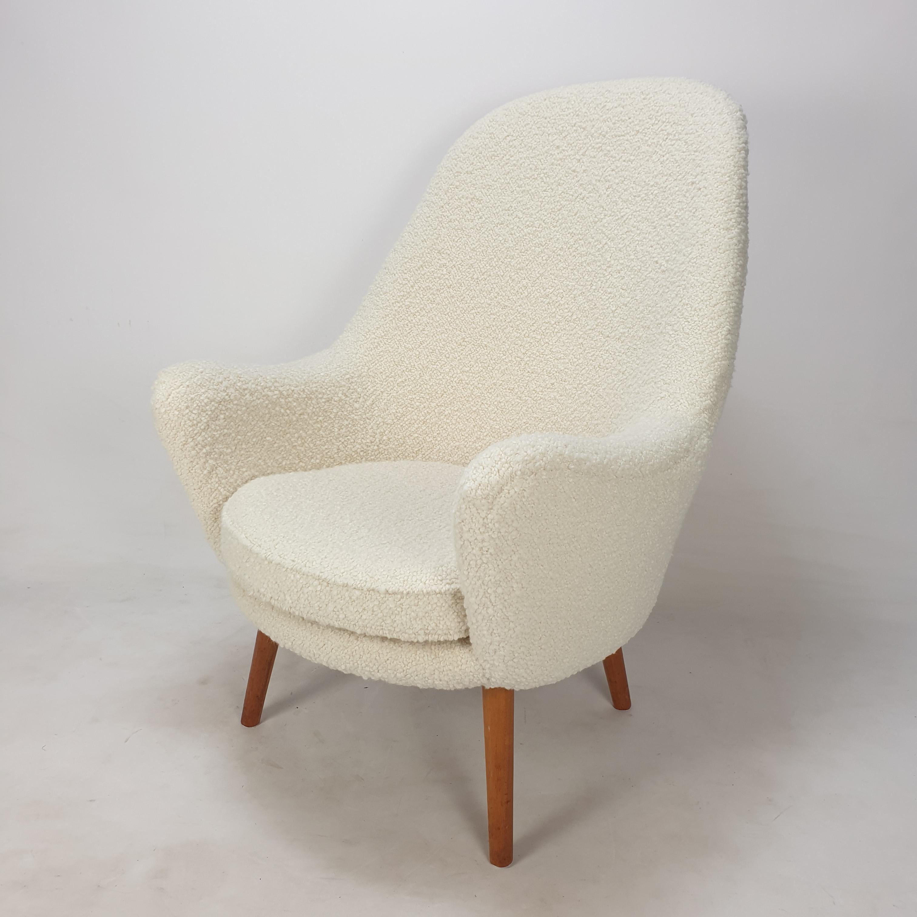 Stunning lounge chair designed and produced in Scandinavia, 1950's. 
It has a very comfortable seat.

The chair is just restored with new foam and new fabric.
It is reupholstered with very soft and cosy bouclé fabric.
