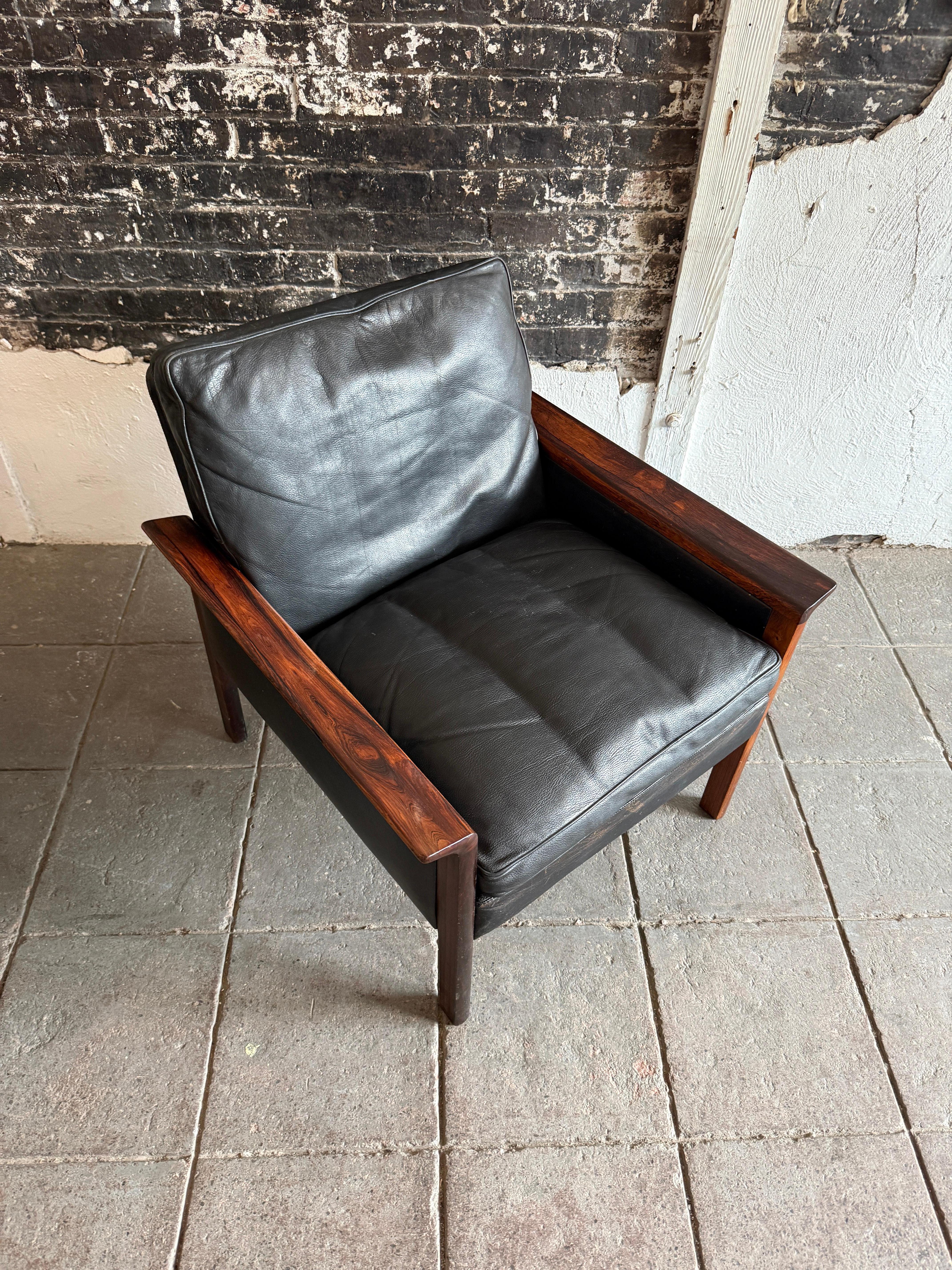 Beautiful Scandinavian Modern black leather lounge chair designed by Hans Olsen. All original soft black leather down filled cushions. Chair is in good vintage condition all straps are good with solid rosewood armrests and legs. Labeled underneath.