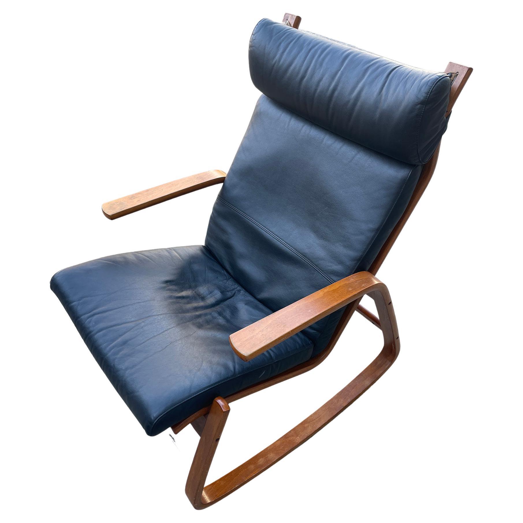 A stylish Scandinavian Modern teak rocking chair designed by Ingmar Relling for Westnofa. The chair features a solid teak bentwood frame and sleek Scandinavian design. It has the black leather upholstery over original canvas. Could be easily